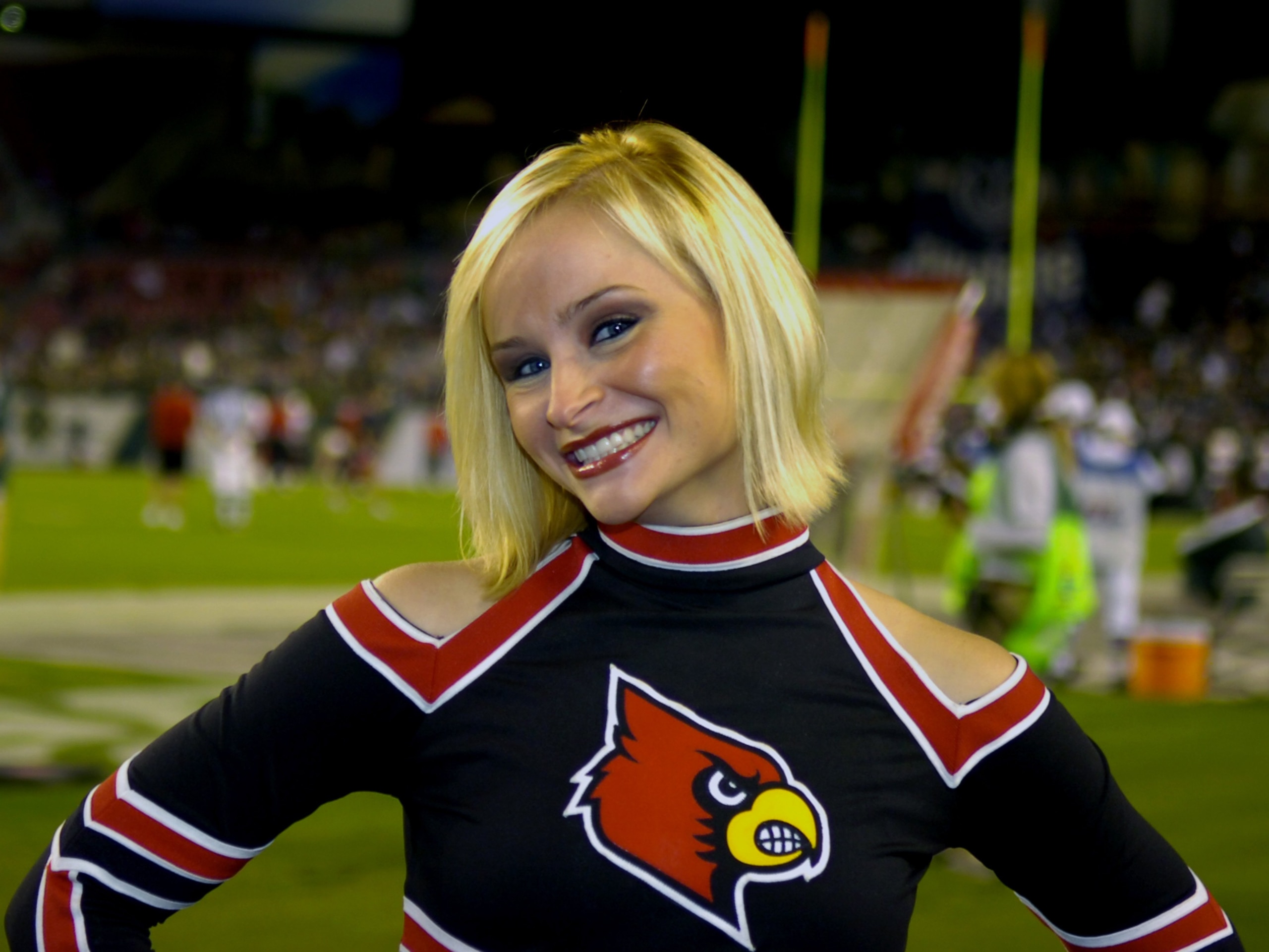 TAMPA, FL - NOVEMBER 17: A cheerleader from the Louisville Cardinals poses on the isdelines during play  against the University of South Florida Bulls at Raymond James Stadium on November 17, 2007 in Tampa, Florida. South Florida won 55-17.  (Photo by Al