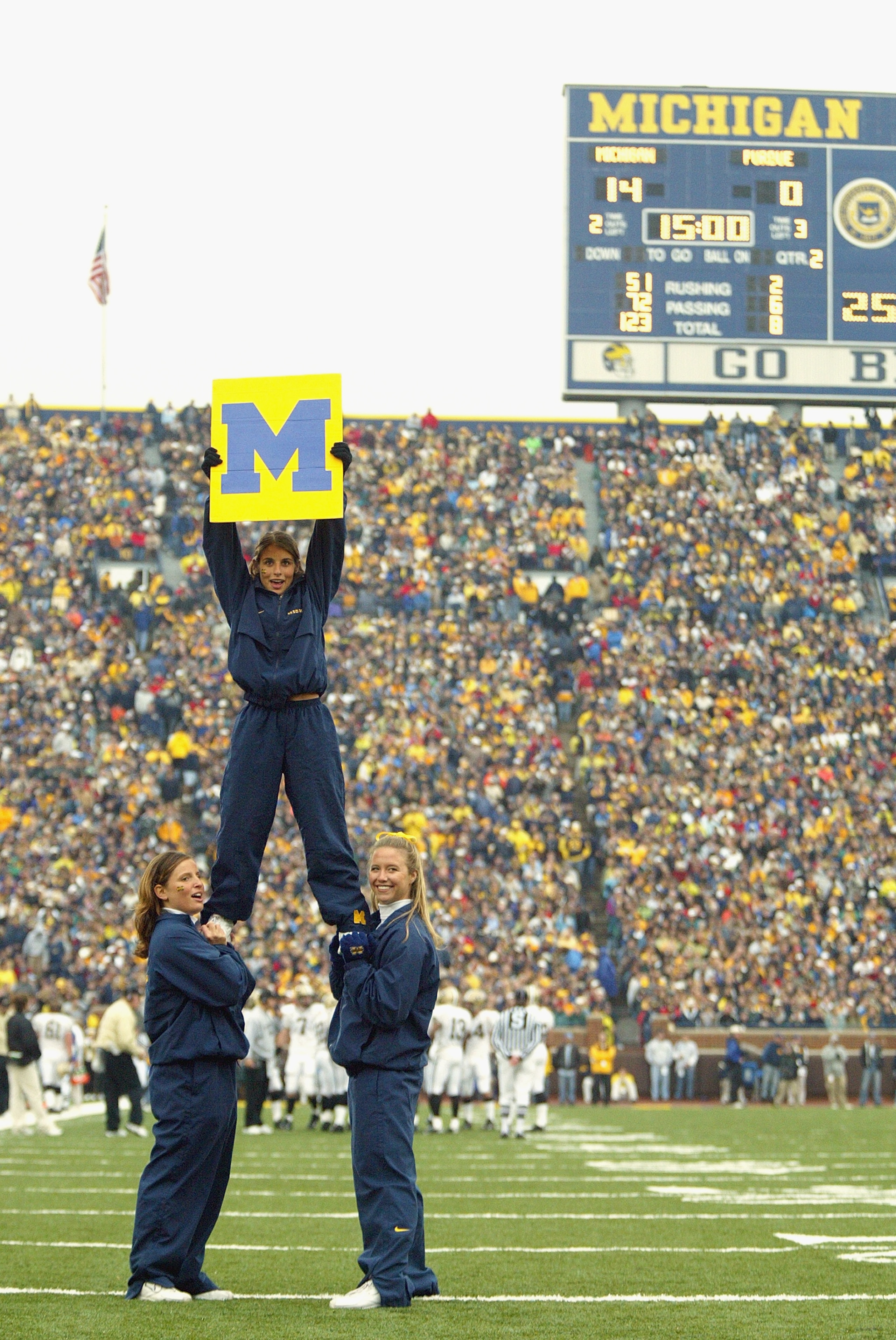 ANN ARBOR, MI - OCTOBER 25:  Cheerleaders support the University of Michigan Wolverines during the NFL game against the Purdue University Boilermakers at Michigan Stadium on October 25, 2003 in Ann Arbor, Michigan. Michigan won 31-3. (Photo by Danny Molos