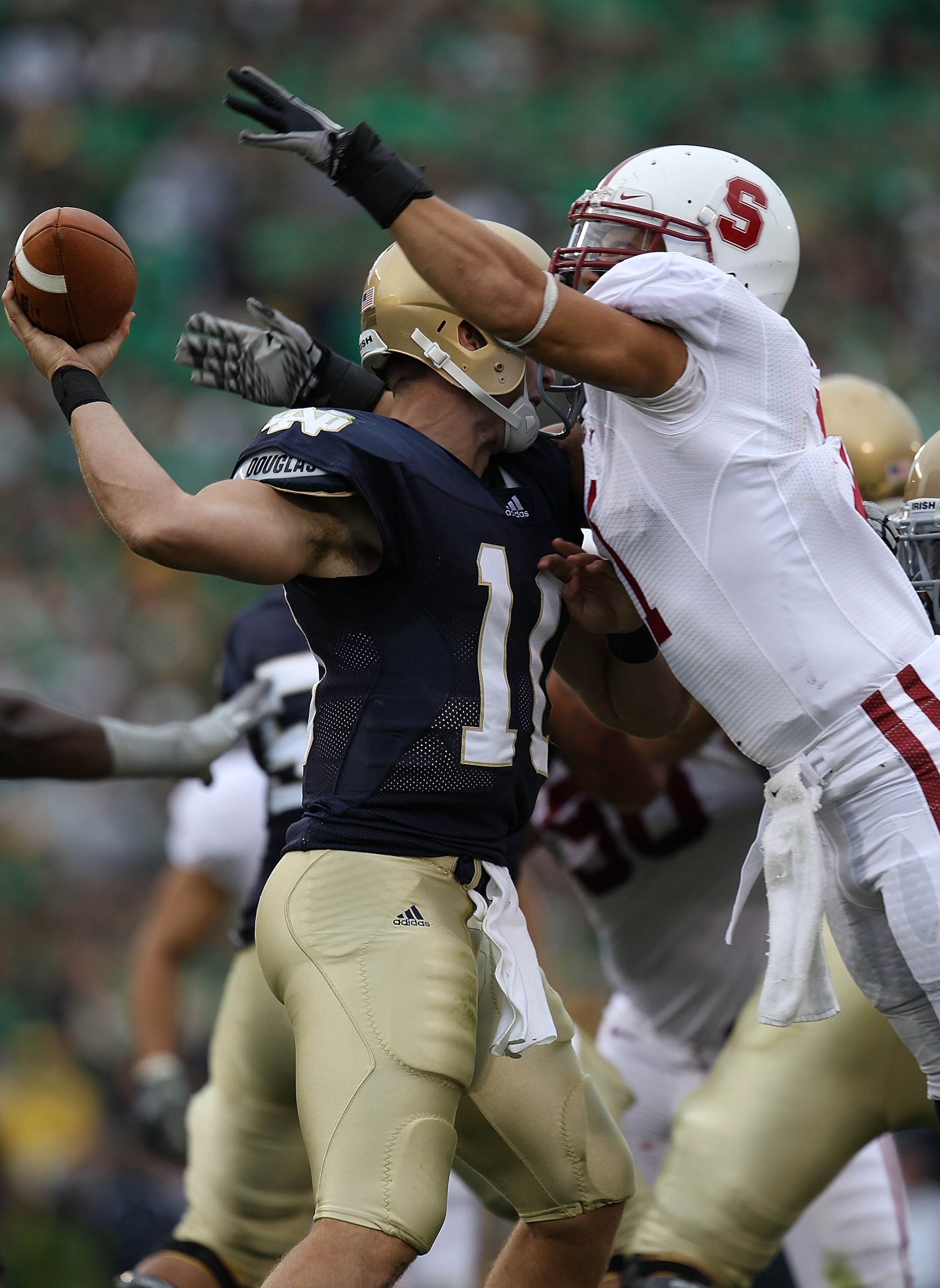 SOUTH BEND, IN - SEPTEMBER 25: Shayne Skov #11 of the Stanford Cardinal hits Dayne Crist #10 of the Notre Dame Fighting Irish forcing Crist to fumble at Notre Dame Stadium on September 25, 2010 in South Bend, Indiana.  (Photo by Jonathan Daniel/Getty Imag