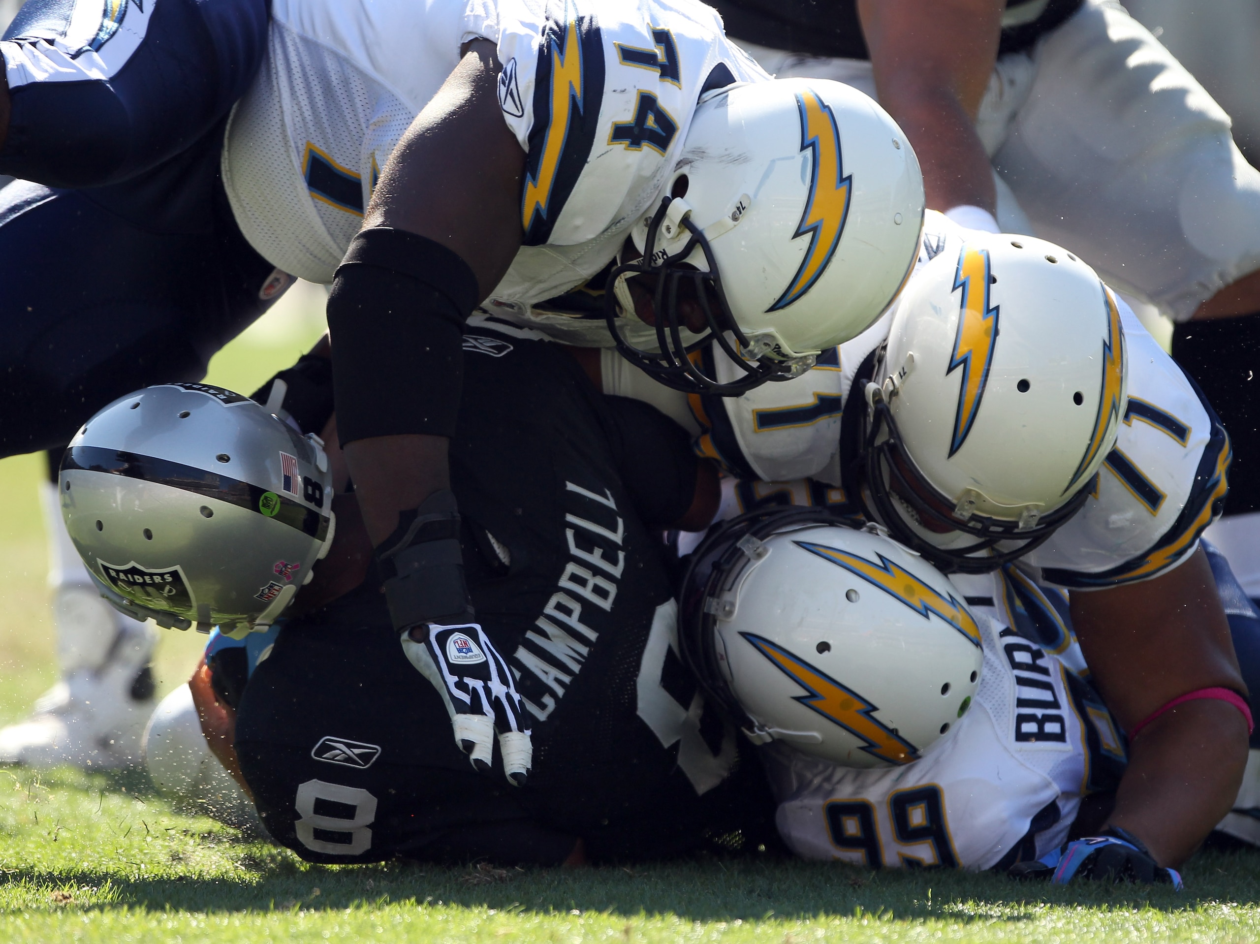 OAKLAND, CA - OCTOBER 10:  Jason Campbell #8 of the Oakland Raiders is tackled by the San Diego Chargers at Oakland-Alameda County Coliseum on October 10, 2010 in Oakland, California.  (Photo by Ezra Shaw/Getty Images)