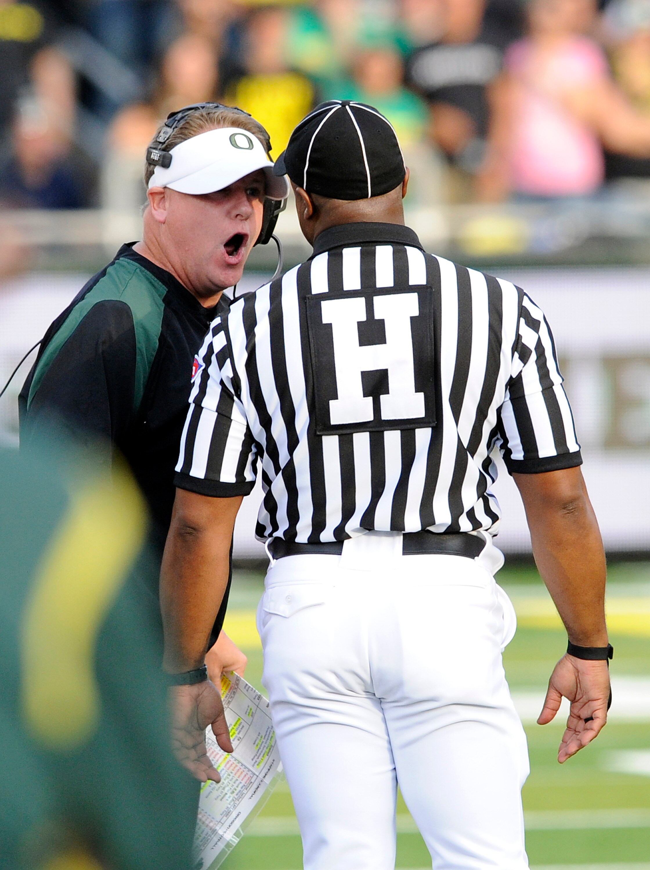 EUGENE, OR - OCTOBER 2: Head coach Chip Kelly of the Oregon Ducks has a few words with head linesman Edwin Walker in the third quarter of the game against the Stanford Cardinal at Autzen Stadium on October 2, 2010 in Eugene, Oregon. Oregon won the game 52 EUGENE, OR - OCTOBER 2: Head coach Chip Kelly of the Oregon Ducks has a few words with head linesman Edwin Walker in the third quarter of the game against the Stanford Cardinal at Autzen Stadium on October 2, 2010 in Eugene, Oregon. Oregon won the game 52
