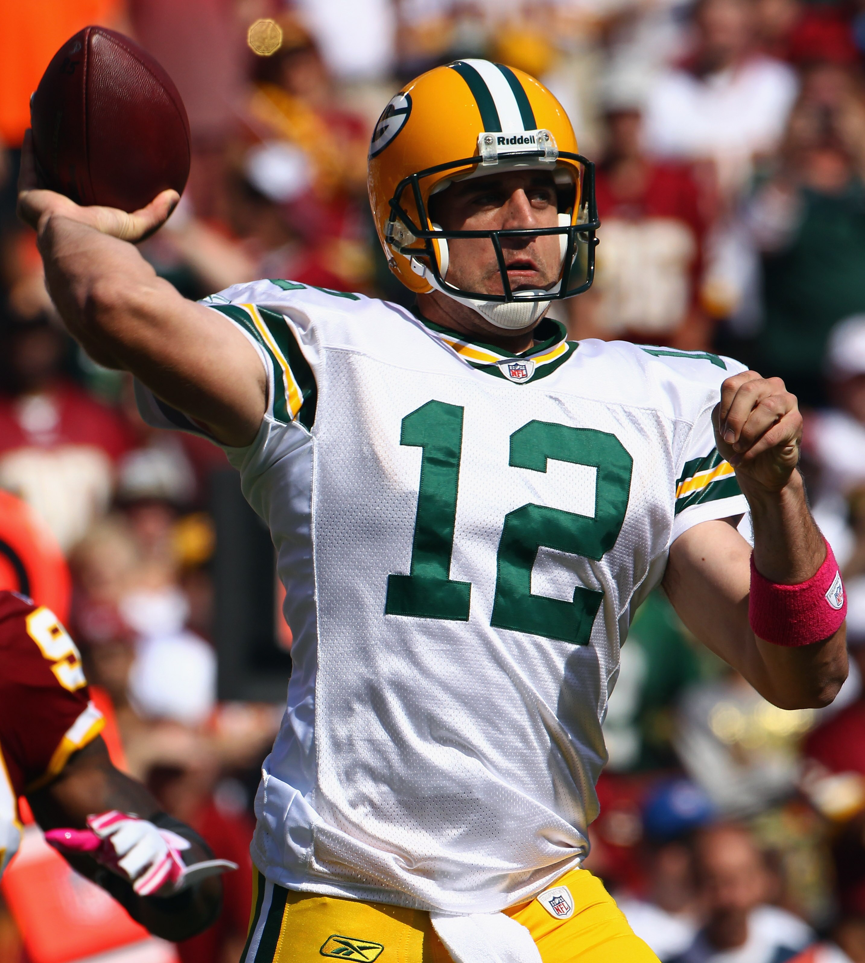 LANDOVER, MD - OCTOBER 10:  Quarterback Aaron Rodgers #12 of the Green Bay Packers throws a pass  against the Washington Redskins at FedExField on October 10, 2010 in Landover, Maryland. The Redskins won the game in overtime 16-13.  (Photo by Win McNamee/