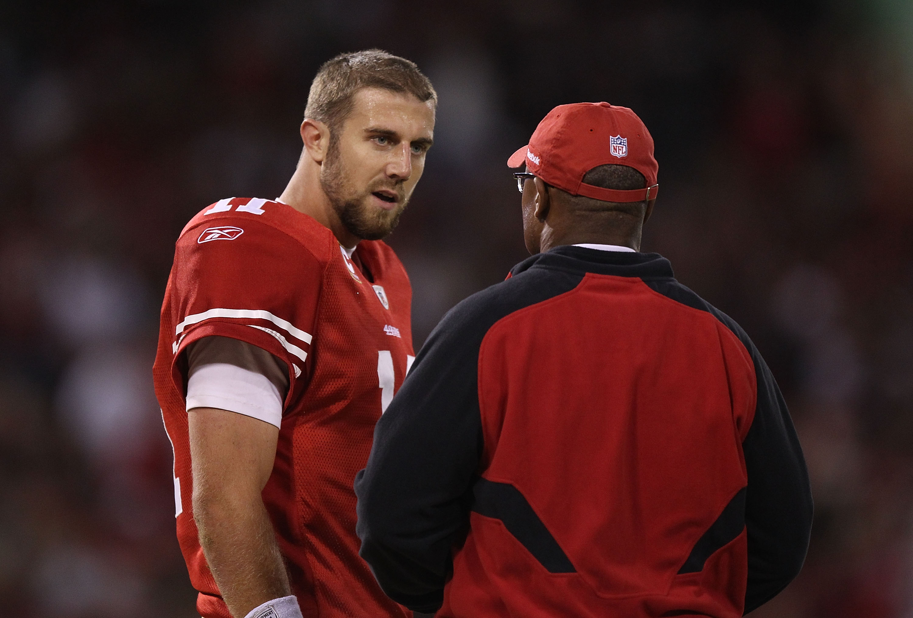 SAN FRANCISCO - OCTOBER 10:  Head coach Mike Singletary of the San Francisco 49ers talks with quarterback Alex Smith #11 against the Philadelphia Eagles during an NFL game at Candlestick Park on October 10, 2010 in San Francisco, California.  (Photo by Je