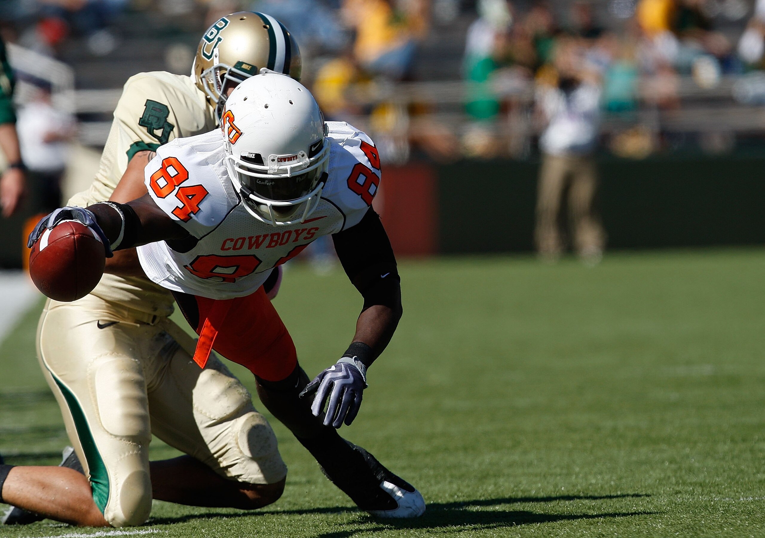 WACO, TX - OCTOBER 24:  Hubert Anyiam #84 of the Oklahoma State Cowboys runs the ball against the Baylor Bears at Floyd Casey Stadium on October 24, 2009 in Waco, Texas.  (Photo by Ronald Martinez/Getty Images)