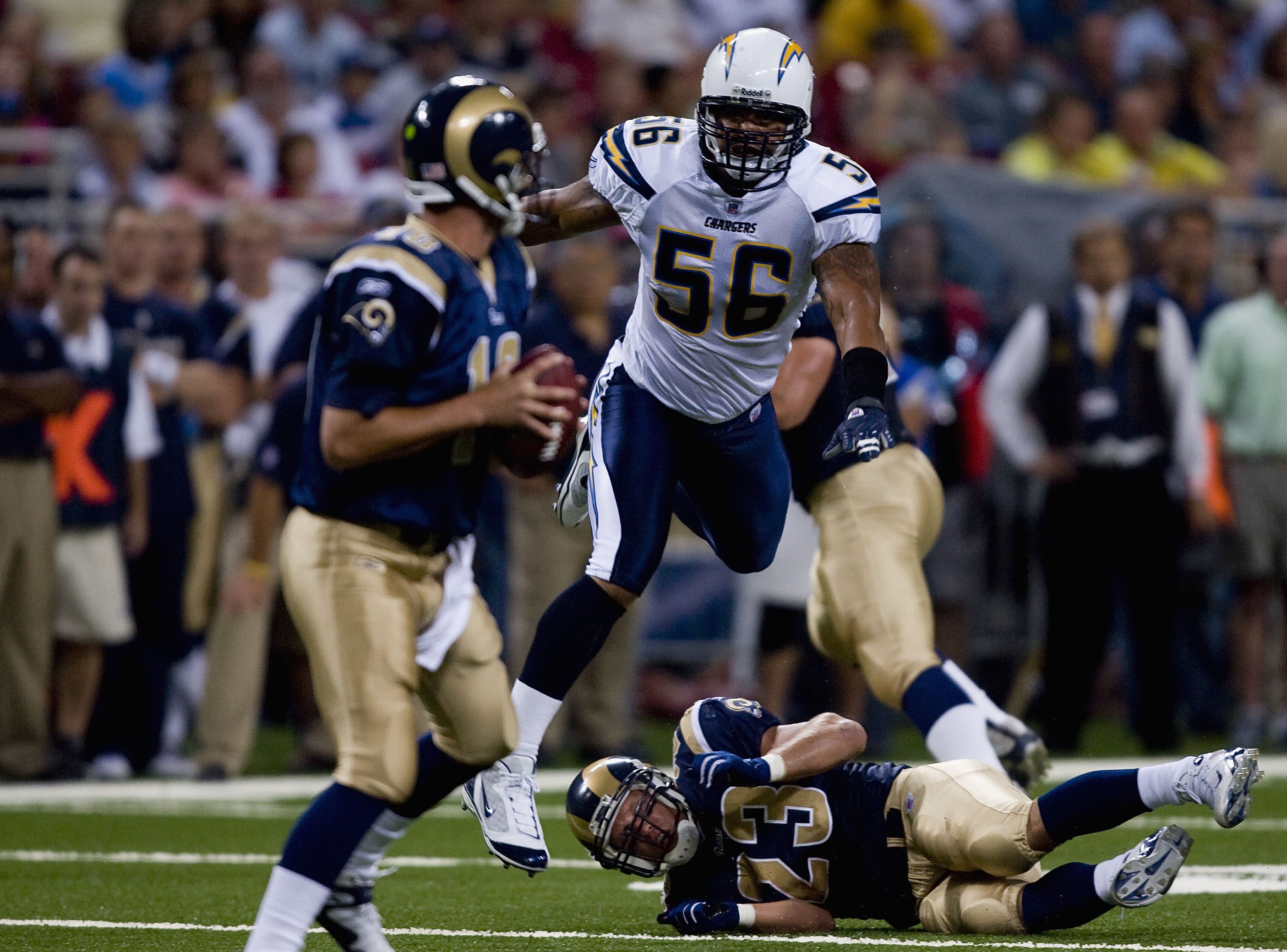 ST. LOUIS, MO - AUGUST 18: Shawne Merriman #56 of the San Diego Chargers hurdles Brian Leonard #23  of the St. Louis Rams as he looks to sack Marc Bulger #10 also of the St. Louis Rams on August 18, 2007 at the Edward Jones Dome in St. Louis, Missouri.  (