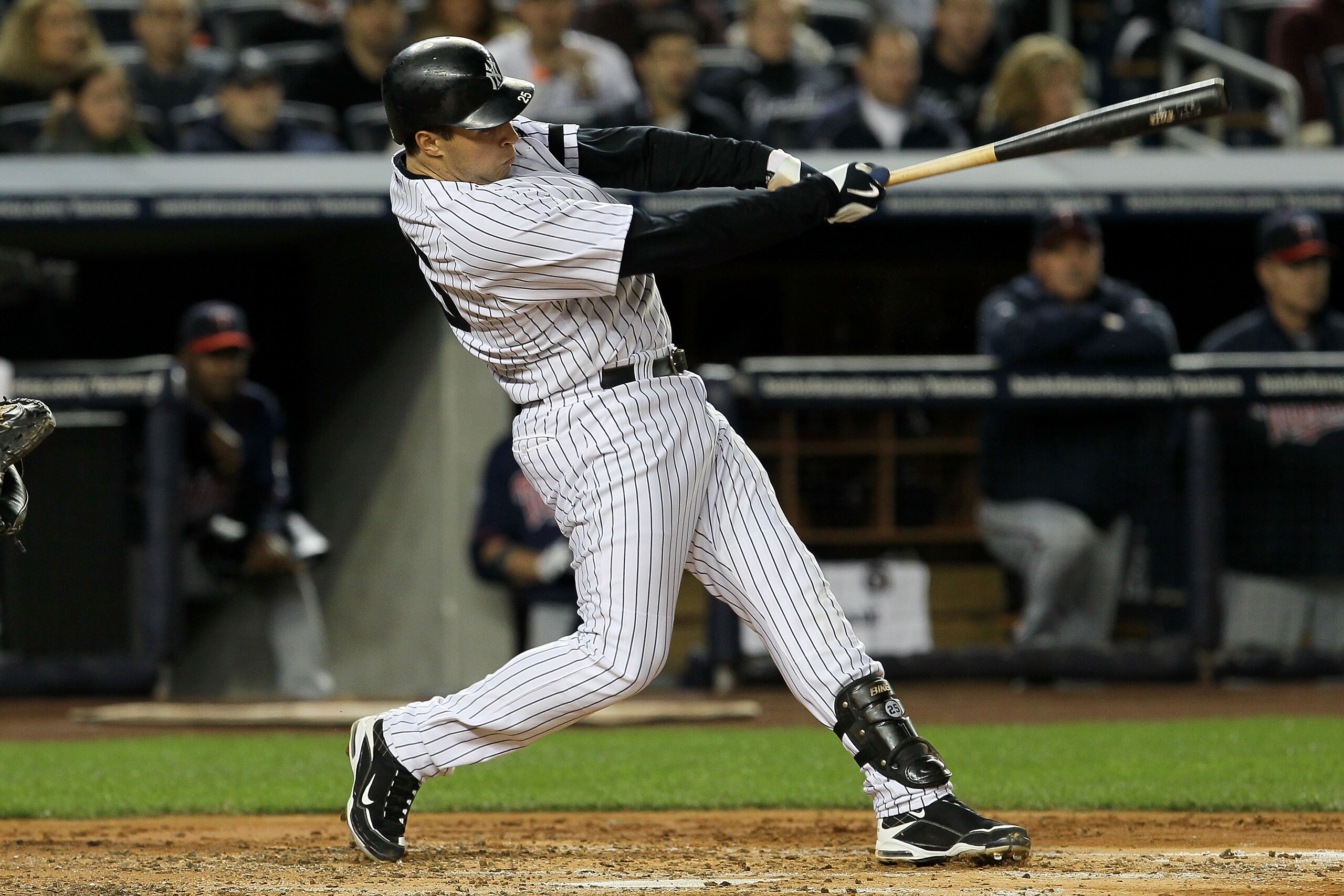 NEW YORK - OCTOBER 09:  Mark Teixeira #25 of the New York Yankees hits a RBI single in the bottom of the third inning against the Minnesota Twins during Game Three of the ALDS part of the 2010 MLB Playoffs at Yankee Stadium on October 9, 2010 in the Bronx