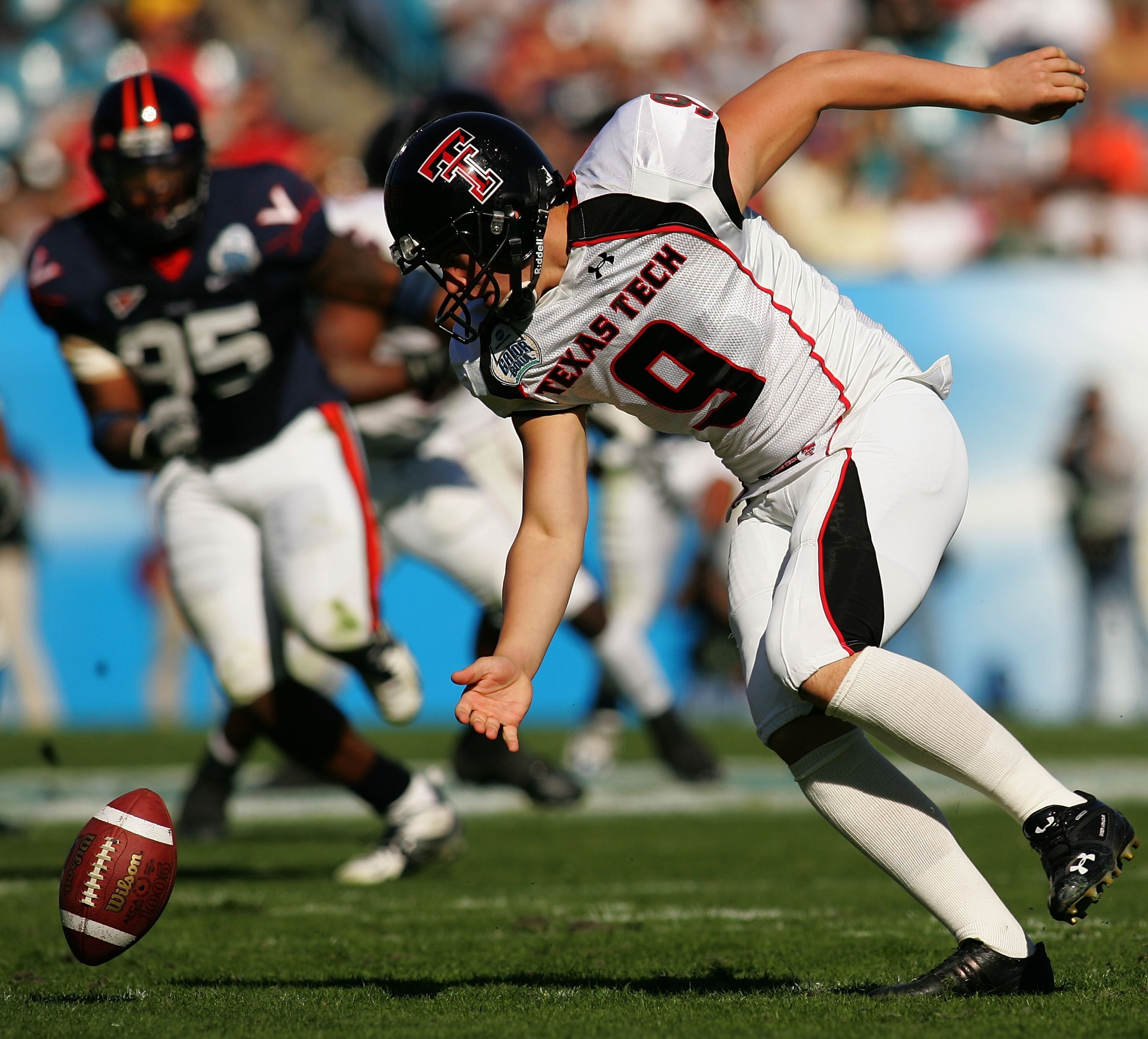 JACKSONVILLE, FL - JANUARY 01:  Jonathan LaCour #9 of the Texas Tech Red Raiders attempts to recover a fumble during the Gator Bowl against the Virginia Cavaliers at Jacksonville Municipal Stadium on January 1, 2008 in Jacksonville, Florida.  (Photo by Sa
