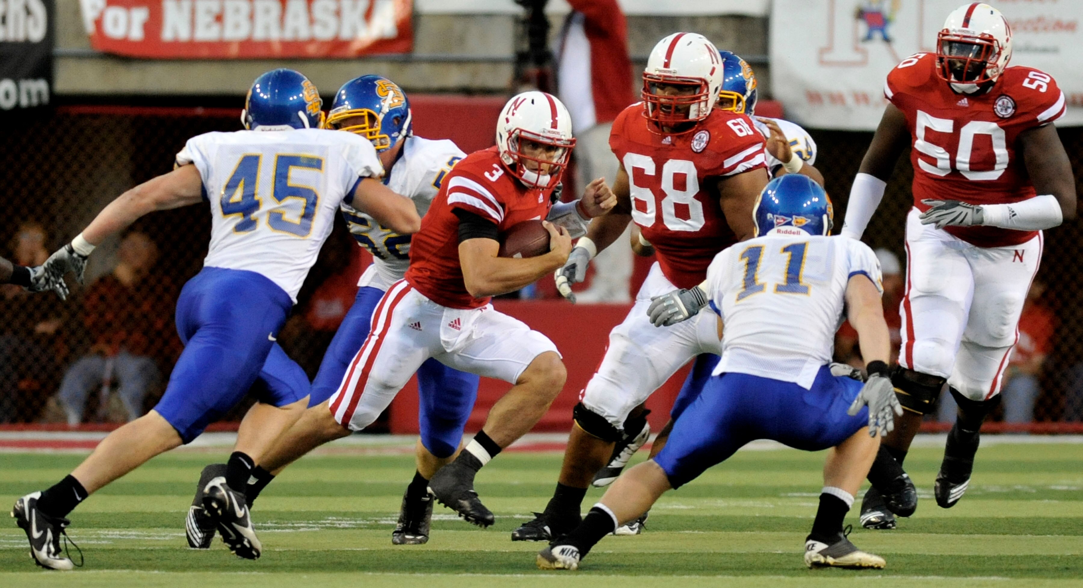 LINCOLN, NE - SEPTEMBER 25: !Quarterback Taylor Martinez #3 of the Nebraska Cornhuskers tries to elude linebacker Michael Lien #45 and linebacker Erich Feller #11of the South Dakota State Jackrabbits during first half action of their game at Memorial Stad LINCOLN, NE - SEPTEMBER 25: !Quarterback Taylor Martinez #3 of the Nebraska Cornhuskers tries to elude linebacker Michael Lien #45 and linebacker Erich Feller #11of the South Dakota State Jackrabbits during first half action of their game at Memorial Stad
