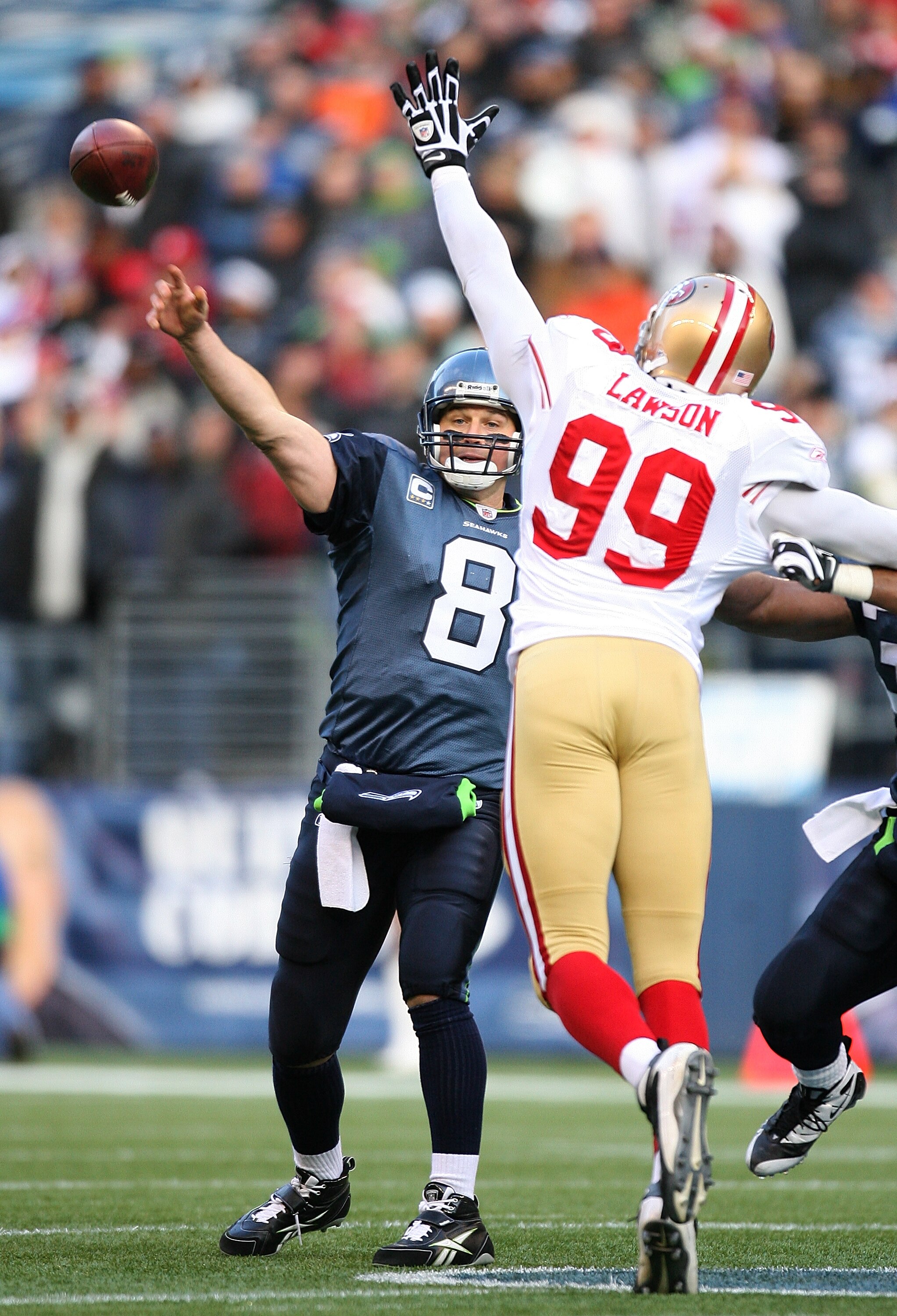 SEATTLE - DECEMBER 06:  Quarterback Matt Hasselbeck #8 of the Seattle Seahawks passes against Manny Lawson #99 of the San Francisco 49ers on December 6, 2009 at Qwest Field in Seattle, Washington. (Photo by Otto Greule Jr/Getty Images)