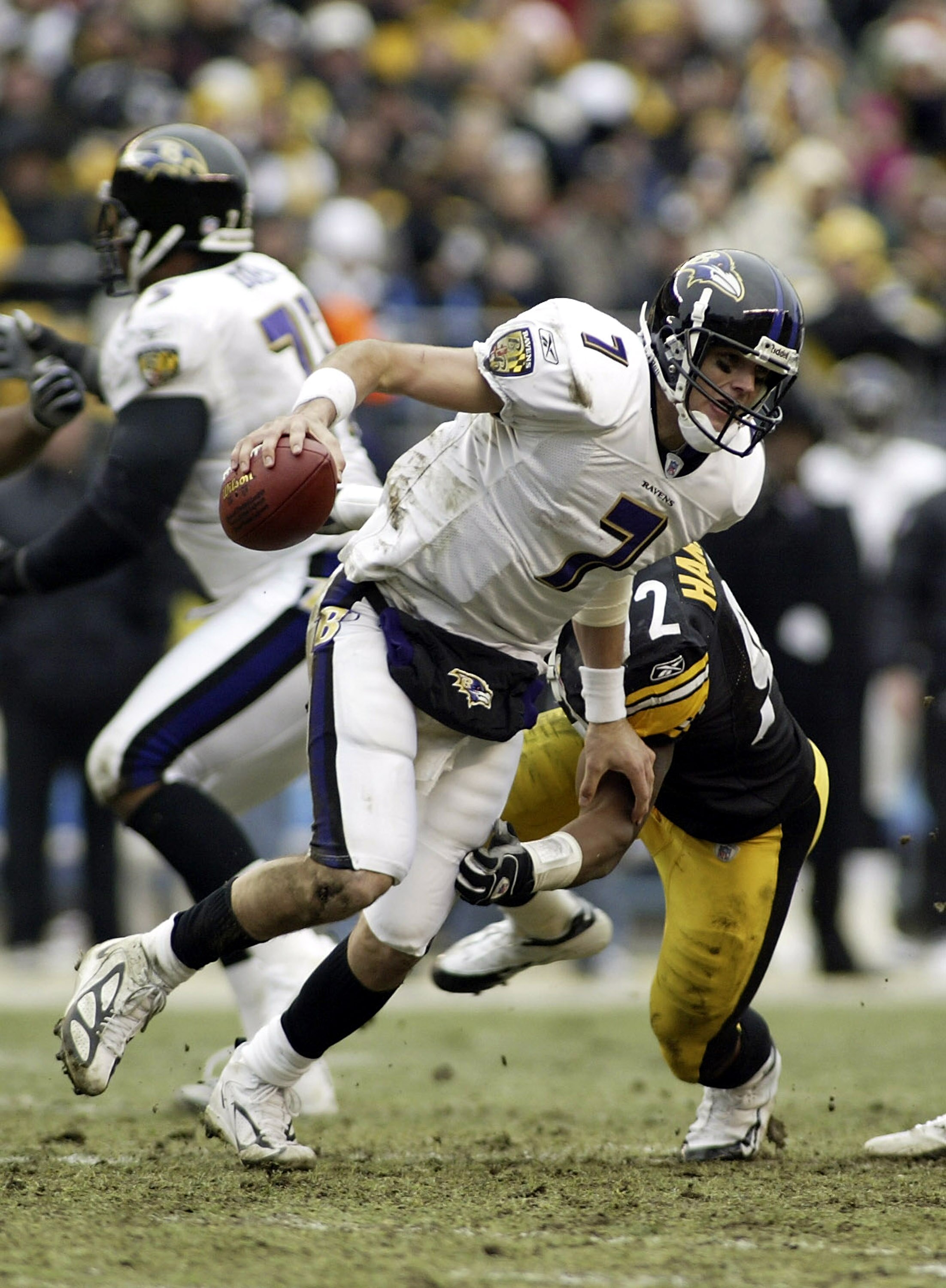 PITTSBURGH, PA - DECEMBER 26: Kyle Boller # 7 of the Baltimore Ravens scrambles away from James Harrison #92 of the Pittsburgh Steelers on December 26, 2004 at Heinz Field in Pittsburgh, Pennsylvania. The Steelers defeated the Ravens 20-7. (Photo by Rick