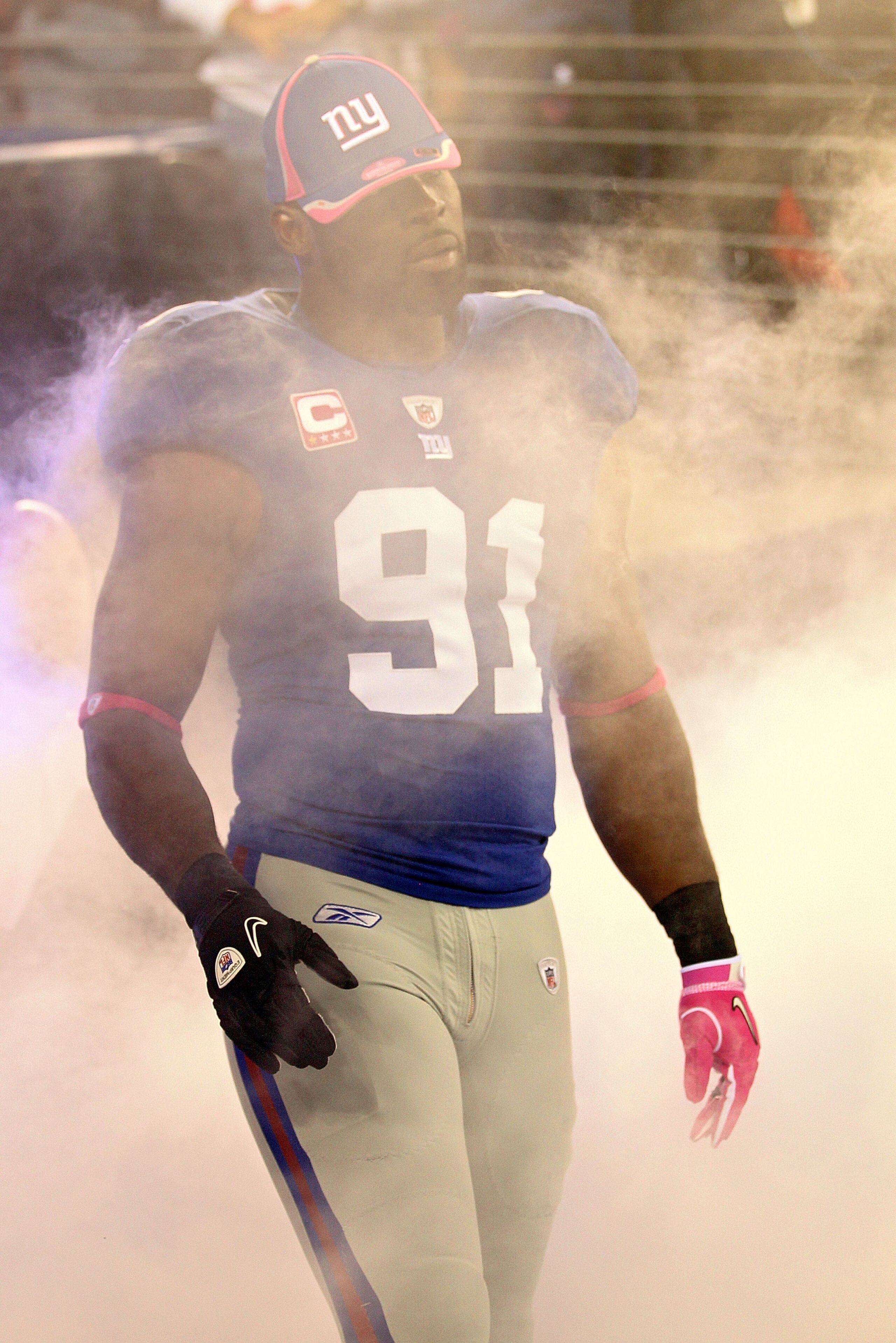 EAST RUTHERFORD, NJ - OCTOBER 03:  Justin Tuck #91 of the New York Giants is introduced before playing against the Chicago Bears at New Meadowlands Stadium on October 3, 2010 in East Rutherford, New Jersey.  (Photo by Chris McGrath/Getty Images)