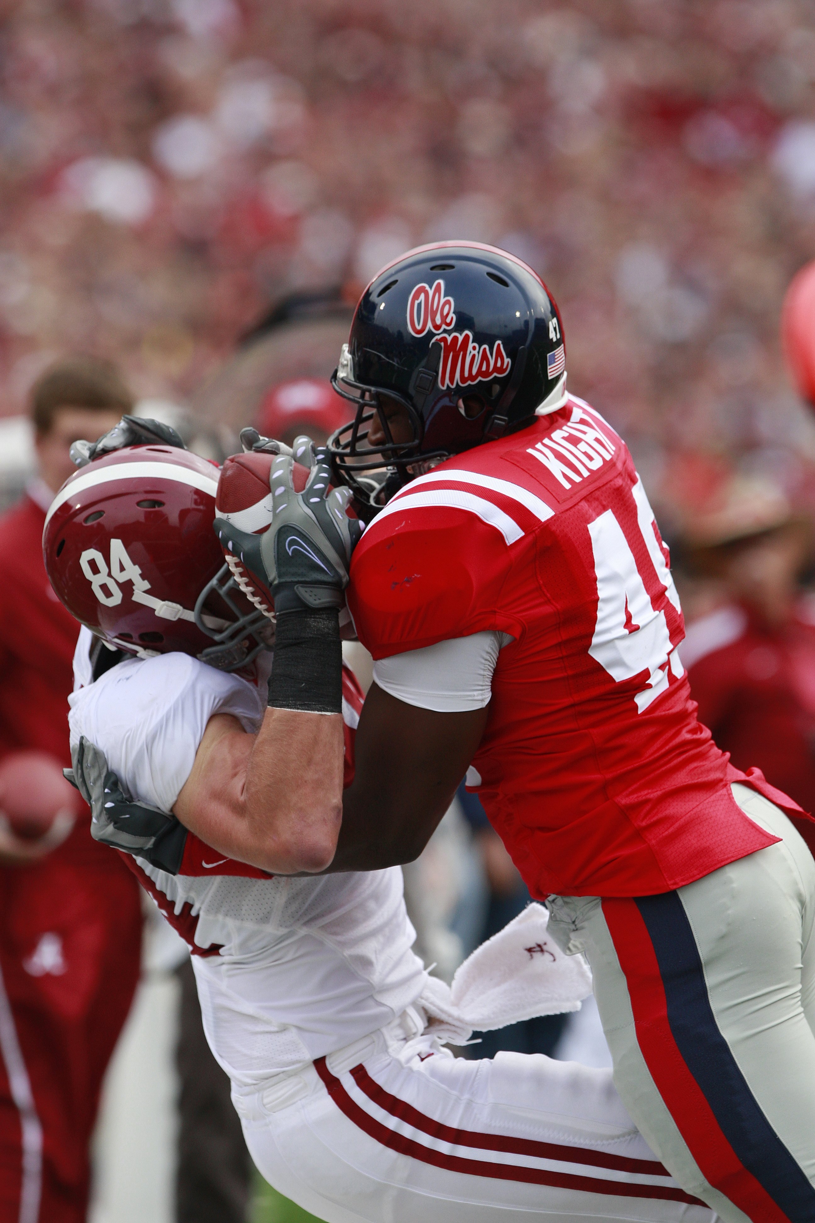 OXFORD, MS - OCTOBER 10: Colin Peek #84 of the Alabama Crimson Tide hauls in a pass as Joel Kight #49 of the Mississippi Rebels defends at Vaught-Hemingway Stadium on October 10, 2009 in Oxford, Mississippi. (Photo by Dave Martin/Getty Images)
