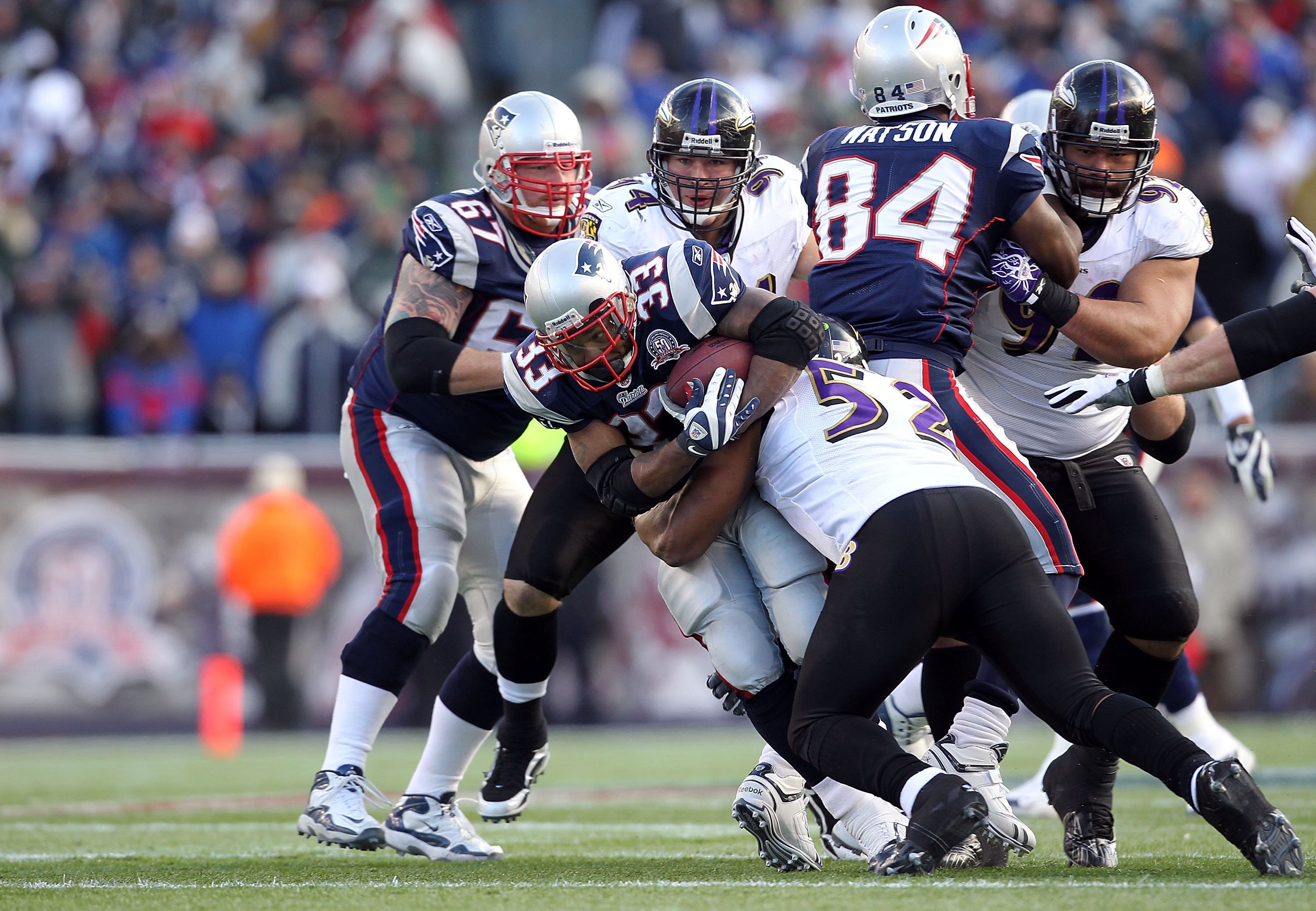 FOXBORO, MA - JANUARY 10:  Kevin Faulk #33 of the New England Patriots runs the ball against Ray Lewis #52, Justin Bannan #94 and Haloti Hgata #92 of the Baltimore Ravens during the 2010 AFC wild-card playoff game at Gillette Stadium on January 10, 2010 i