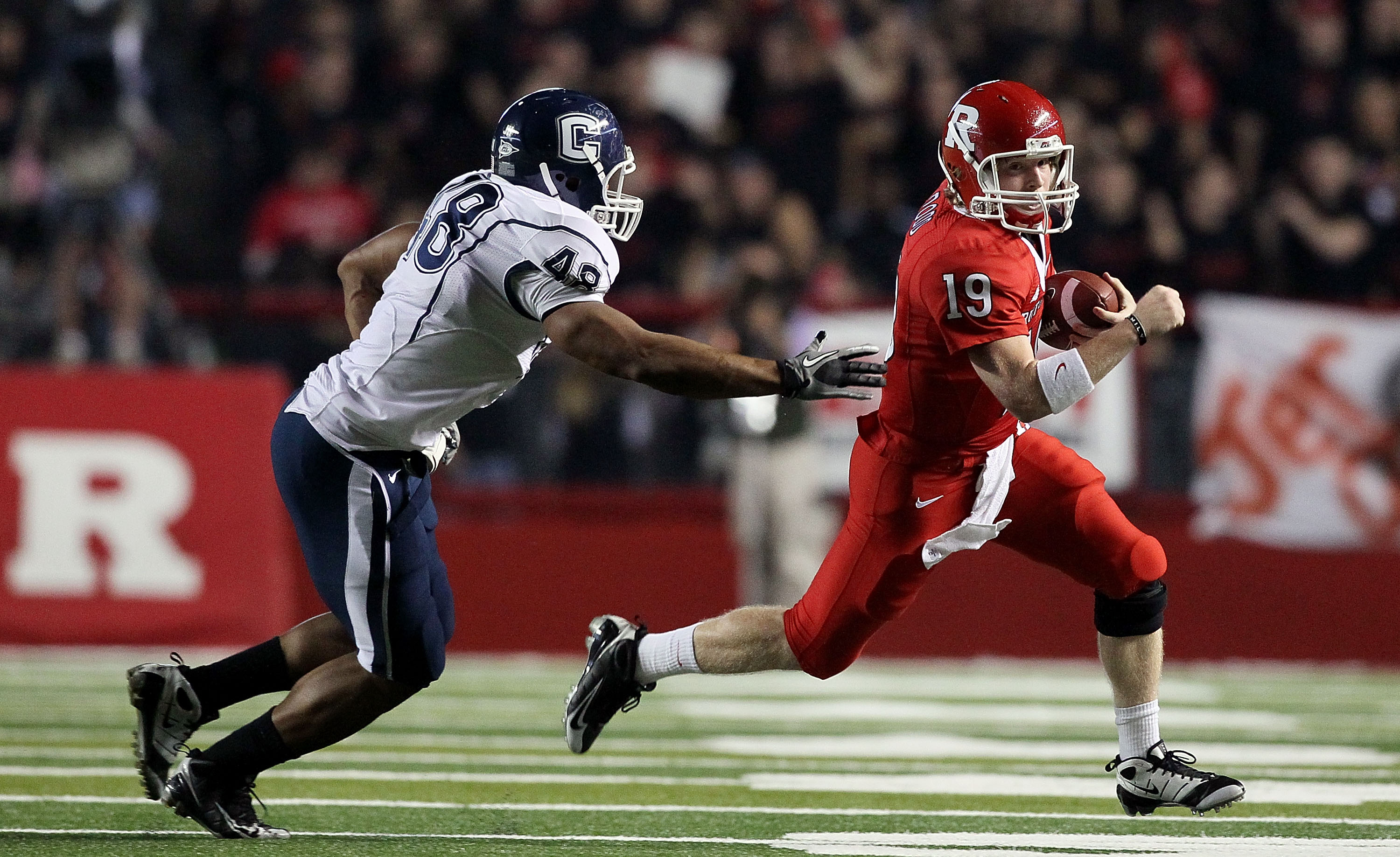 PISCATAWAY, NJ - OCTOBER 08:  Chas Dodd #19 of the Rutgers Scarlet Knights runs the ball against Trevardo Williams #48 of the Connecticut Huskies at Rutgers Stadium on October 8, 2010 in Piscataway, New Jersey.  (Photo by Jim McIsaac/Getty Images)