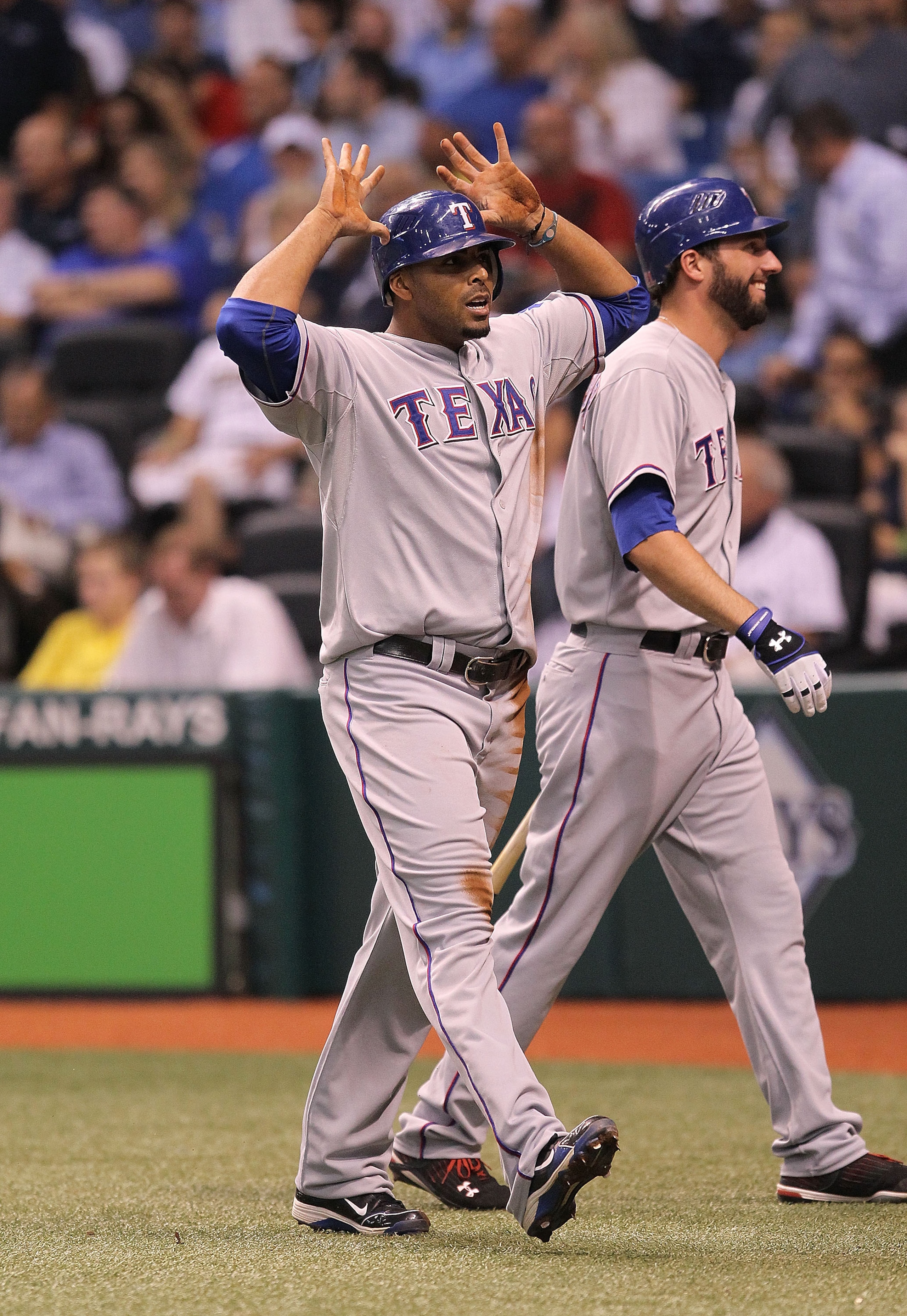 ST. PETERSBURG, FL - OCTOBER 12:  Nelson Cruz #17 of the Texas Rangers gives the deer horns after scoring on a throwing error by catcher Kelly Shoppach during Game 5 of the ALDS at Tropicana Field on October 12, 2010 in St. Petersburg, Florida.  (Photo by