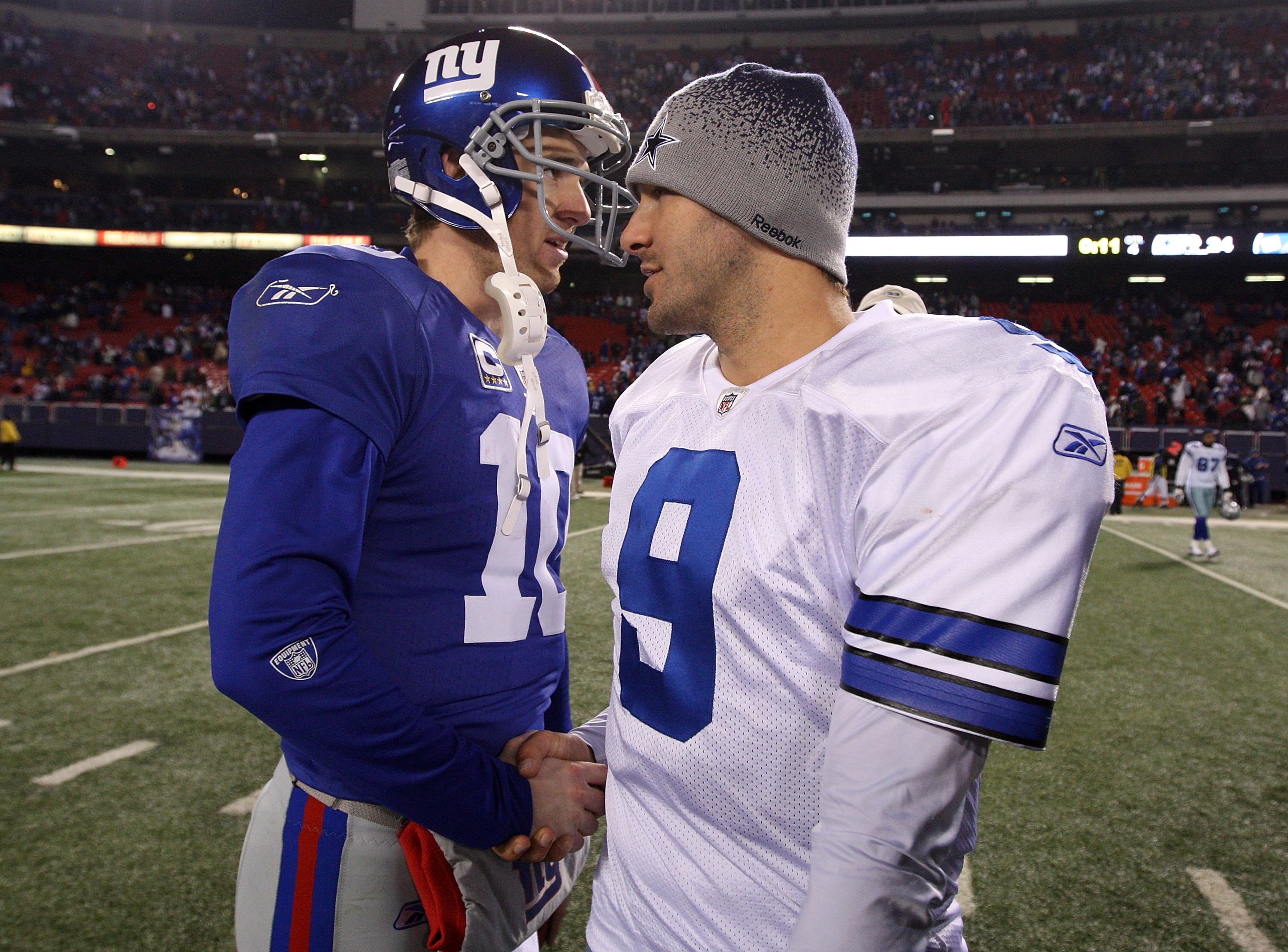 EAST RUTHERFORD, NJ - DECEMBER 06: Eli Manning #10 of the New York Giants is congratulated by Tony Romo #9 of the Dallas Cowboys after the Giants won 31-24 at Giants Stadium on December 6, 2009 in East Rutherford, New Jersey. (Photo by Jim McIsaac/Getty I