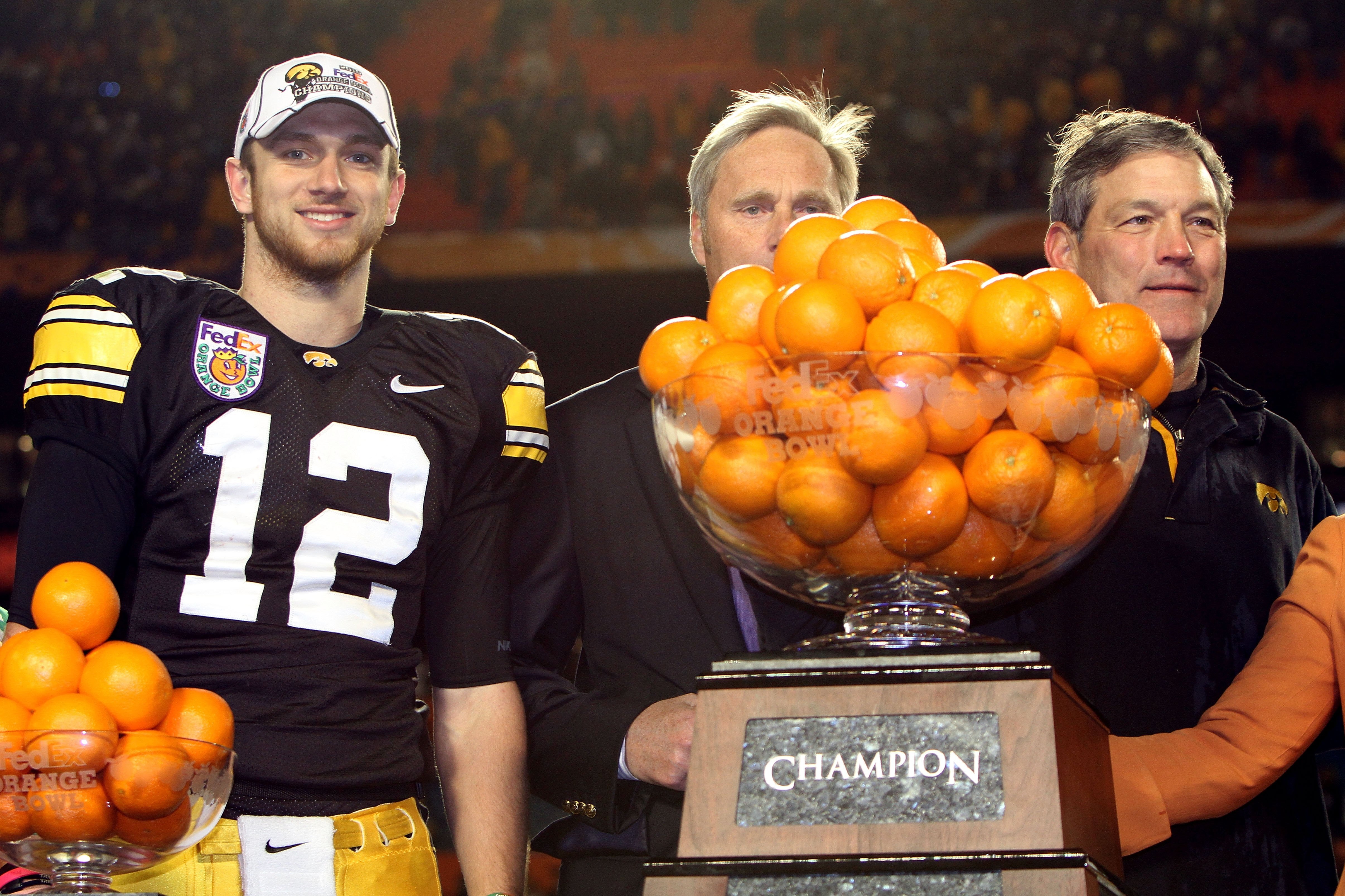 MIAMI GARDENS, FL - JANUARY 05:  Ricky Stanzi #12 and head coach Kirk Ferentz  (R) of the Iowa Hawkeyes celebrate with the throphy after Iowa won 24-14 against the Georgia Tech Yellow Jackets during the FedEx Orange Bowl at Land Shark Stadium on January 5