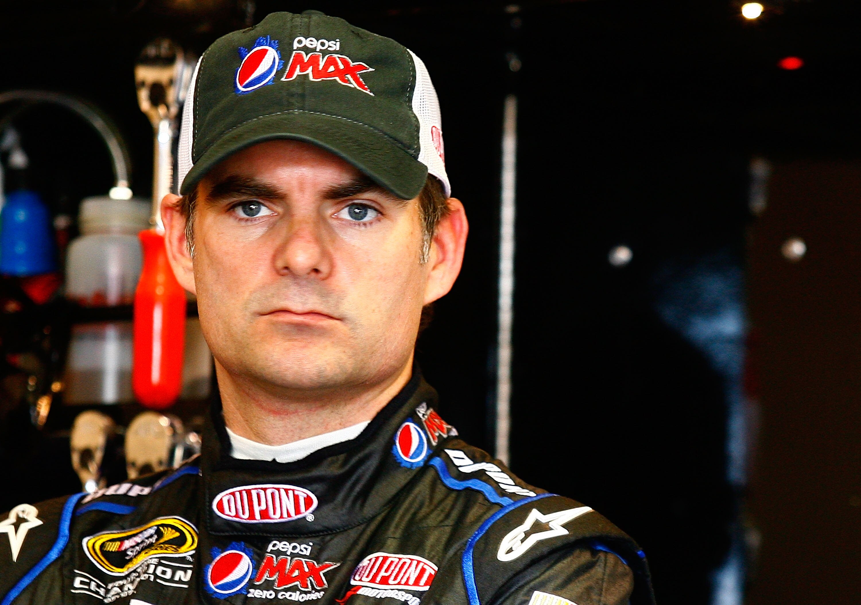FONTANA, CA - OCTOBER 08:  Jeff Gordon, driver of the #24 DuPont Chevrolet, stands in the garage during practice for the NASCAR Sprint Cup Series Pepsi Max 400 on October 8, 2010 in Fontana, California.  (Photo by Jason Smith/Getty Images for NASCAR)