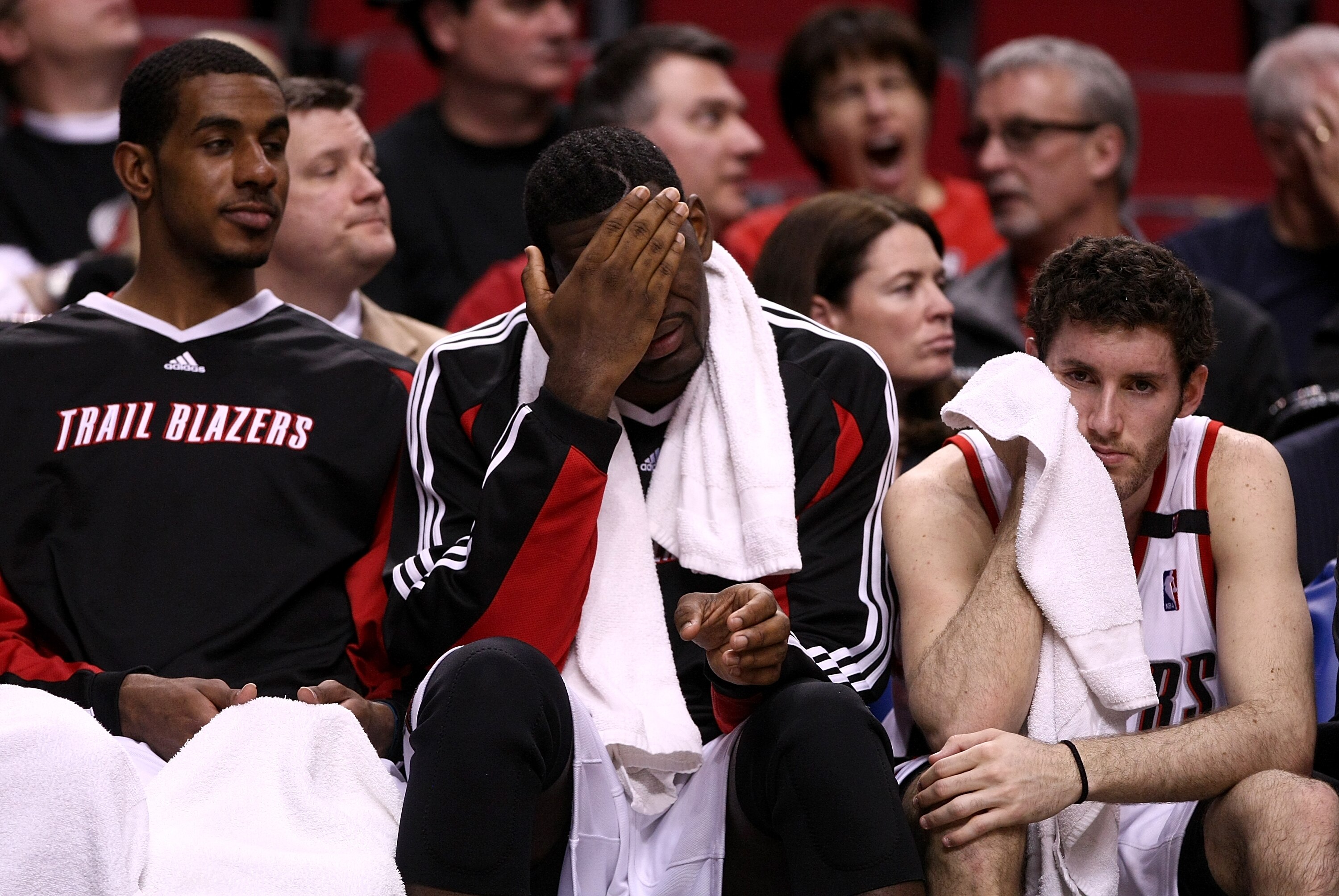 PORTLAND, OR - APRIL 18:  LaMarcus Aldridge (L) #12, Greg Oden (C) #52 and Rudy Fernandez (R) #5 of the Portland Trail Blazers watch the game from the bench against the Houston Rockets during Game 1 of the Western Conference Quarterfinals of the NBA Playo