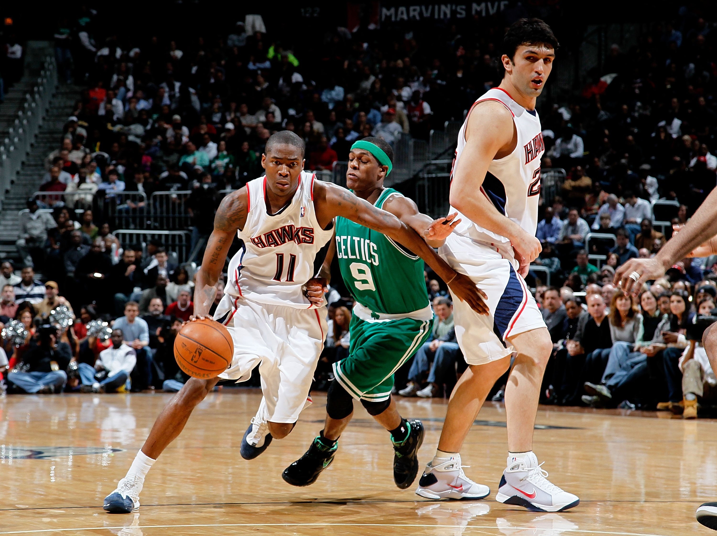 ATLANTA - JANUARY 29:  Jamal Crawford #11 and Zaza Pachulia #27 of the Atlanta Hawks against Rajon Rondo #9 of the Boston Celtics at Philips Arena on January 29, 2010 in Atlanta, Georgia.  NOTE TO USER: User expressly acknowledges and agrees that, by down
