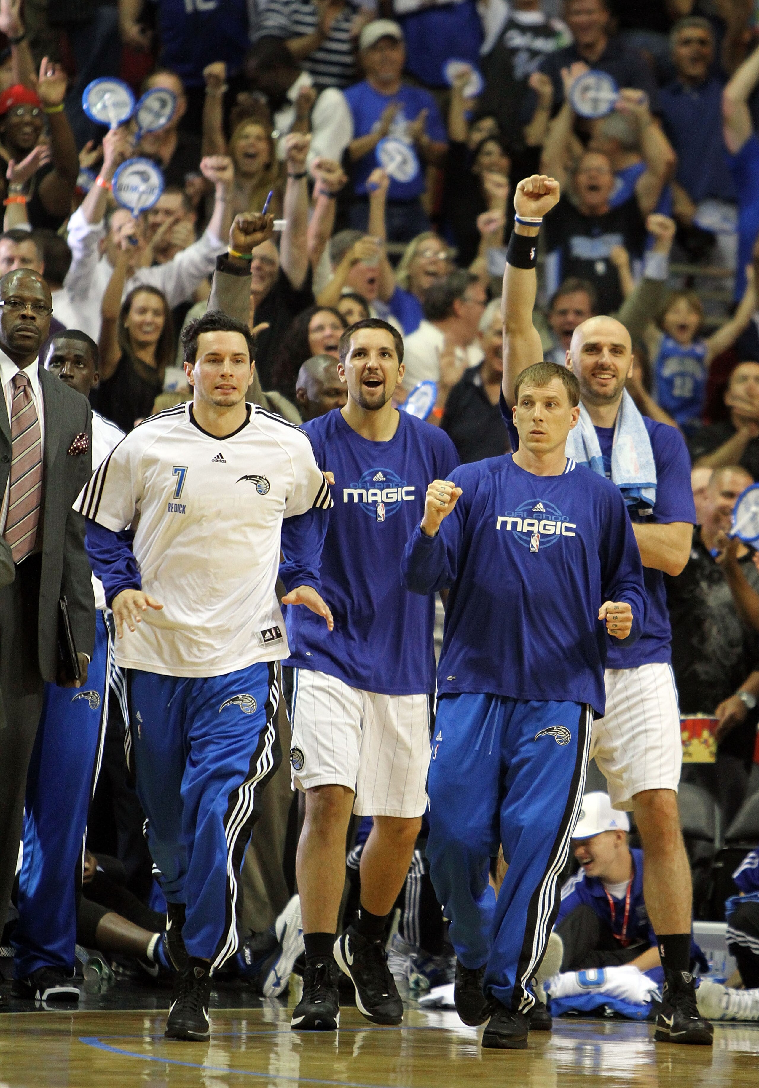 ORLANDO, FL - MAY 06:  J.J. Redick #7, Ryan Anderson #33, Jason Williams #44 and Marcin Gortat #13 of the Orlando Magic celebrate after Jameer Nelson #14 hits a desperation three-point basket with less than a second left in the third quarter to give the M