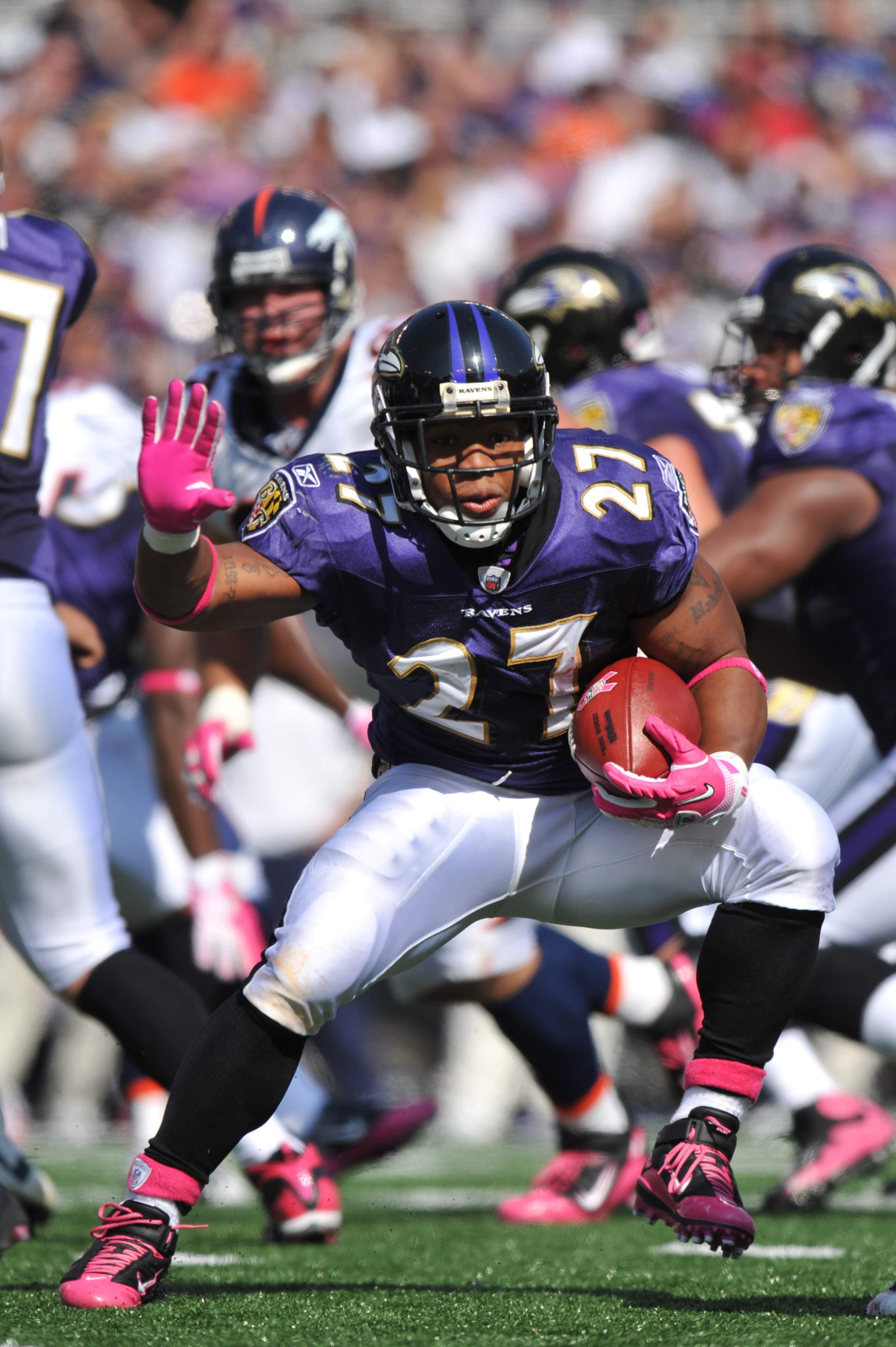 BALTIMORE, MD - OCTOBER 10: Ray Rice #27 of the Baltimore Ravens runs the ball against the Denver Broncos at M&T Bank Stadium on October 10, 2010 in Baltimore, Maryland. Players wore pink in recognition of Breast Cancer Awareness Month. The Ravens defeate