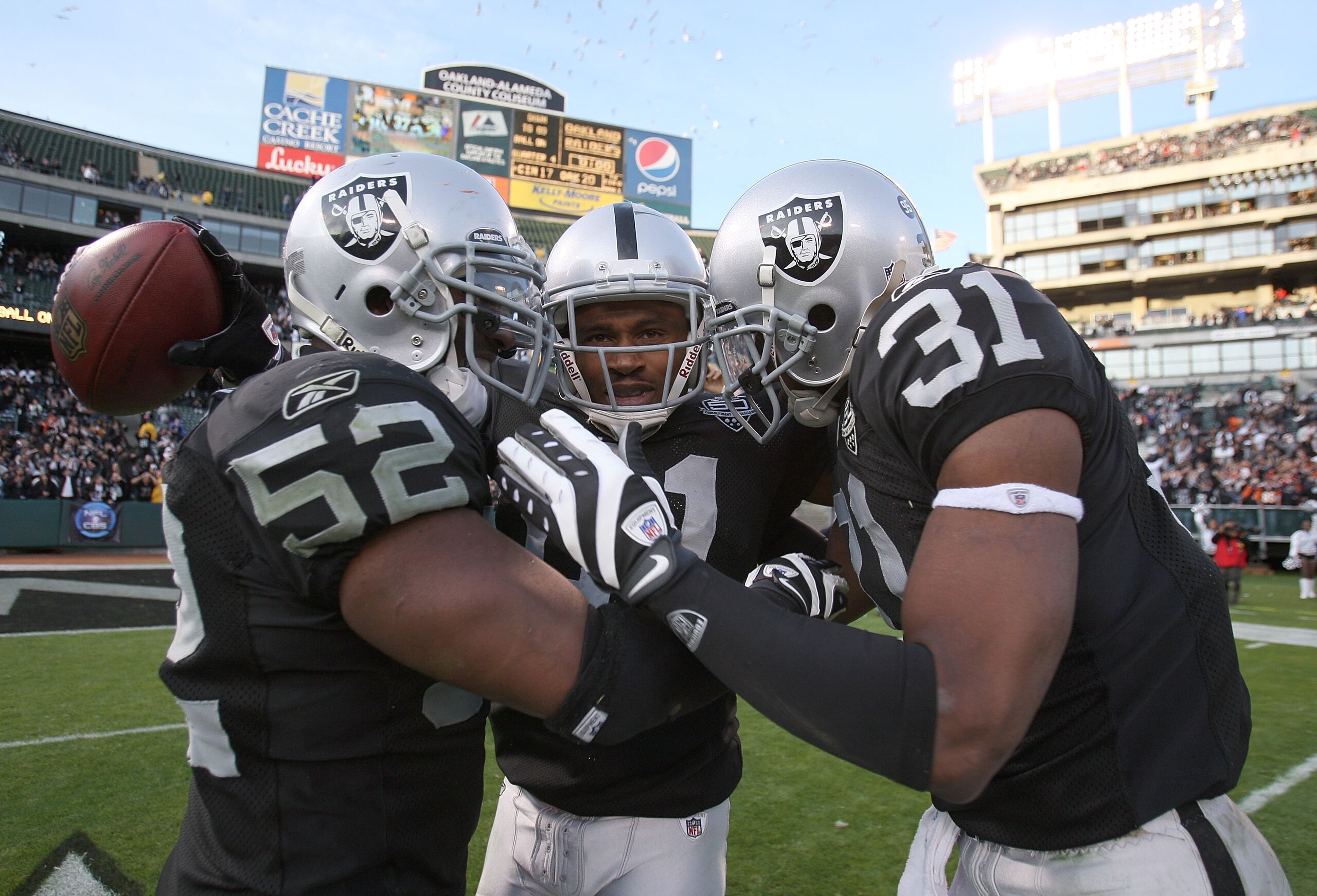 OAKLAND, CA - NOVEMBER 22:  Nnamdi Asomugha #21 of the Oakland Raiders celebrates with Hiram Eugene #31 and Kirk Morrison #52 after defeating the Cincinnati Bengals during an NFL game at Oakland-Alameda County Coliseum on November 22, 2009 in Oakland, Cal