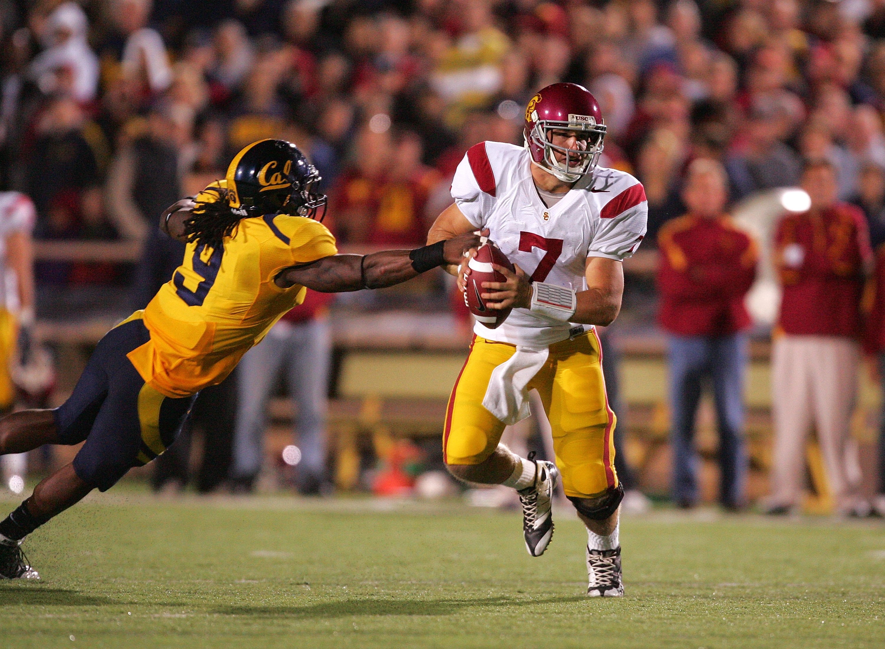 BERKELEY, CA - OCTOBER 03:  Matt Barkley #7 of the USC Trojans tries to get away from Eddie Young #9 of the California Golden Bears at California Memorial Stadium on October 3, 2009 in Berkeley, California.  (Photo by Ezra Shaw/Getty Images)