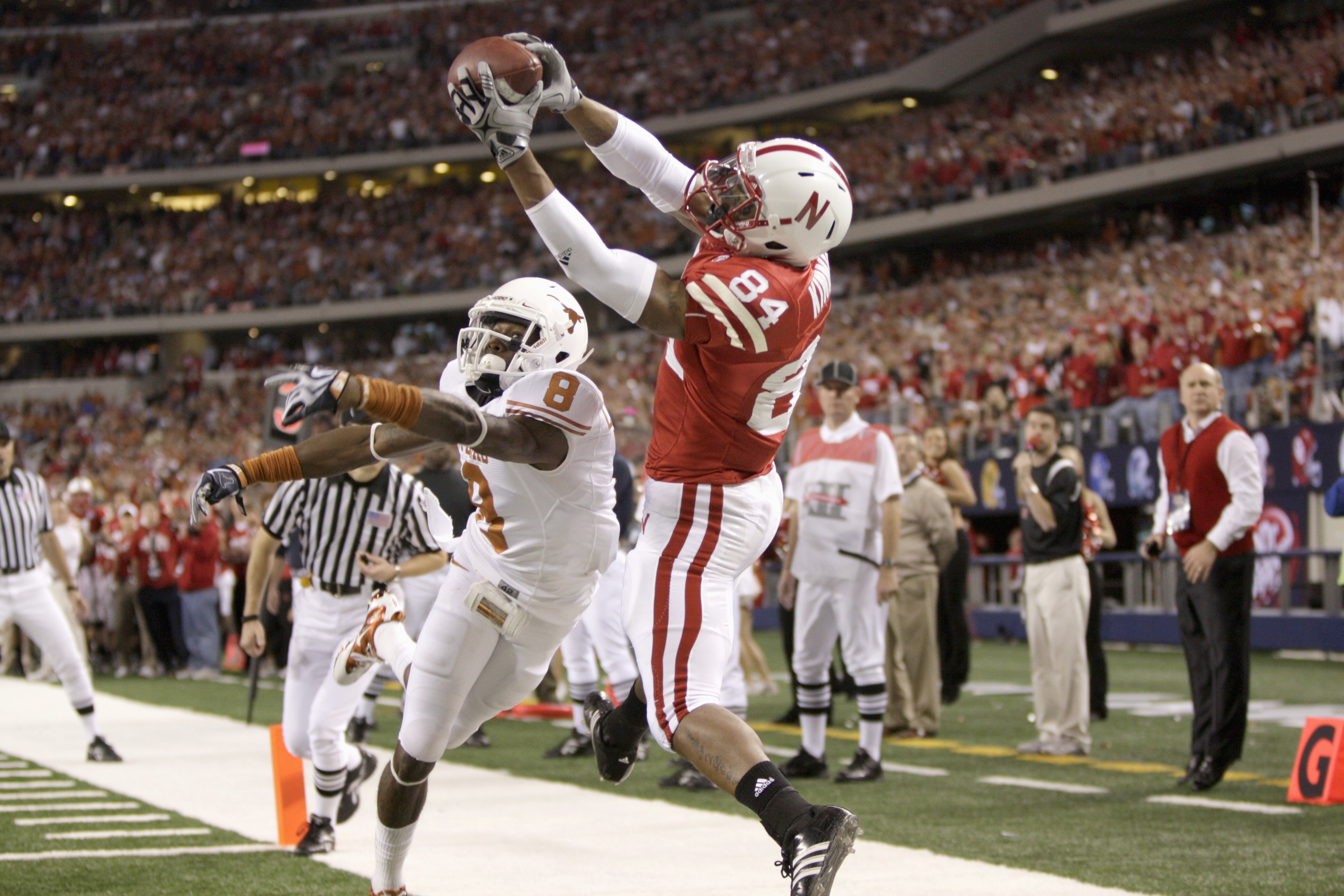 ARLINGTON, TX - DECEMBER 5: Brandon Kinnie #84 of the Nebraska Cornhuskers leaps for the catch against Chykie Brown #8 of the Texas Longhorns during Big 12 Football Championship game at Cowboys Stadium on December 5, 2009 in Arlington, Texas. (Photo by Ja