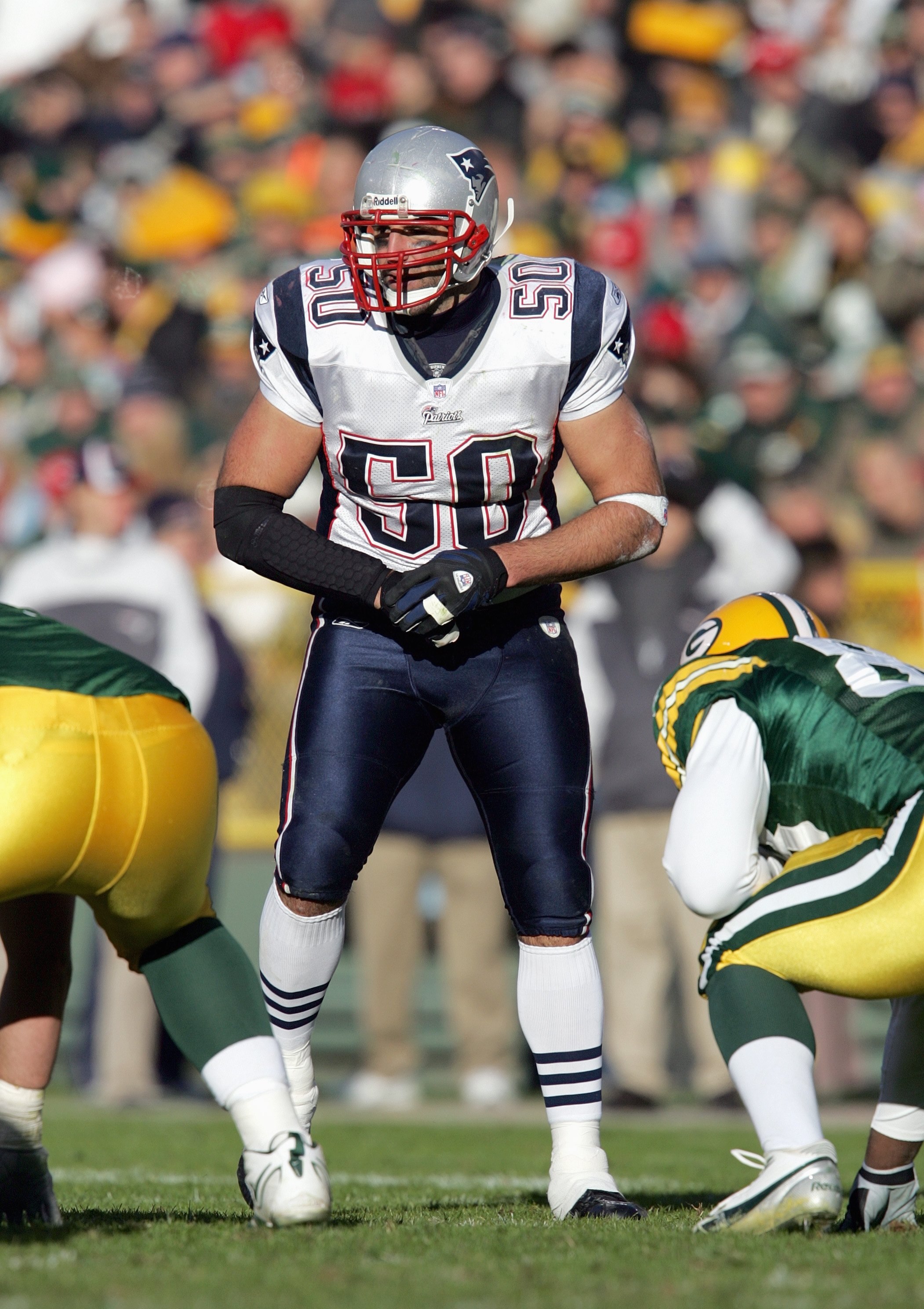 GREEN BAY, WI - NOVEMBER 19:  Mike Vrabel #50 of the New England Patriots gets ready on the line of scrimmage during the game against the Green Bay Packers on November 19, 2006 at Lambeau Field in Green Bay, Wisconsin. The Patriots defeated the Packers 35