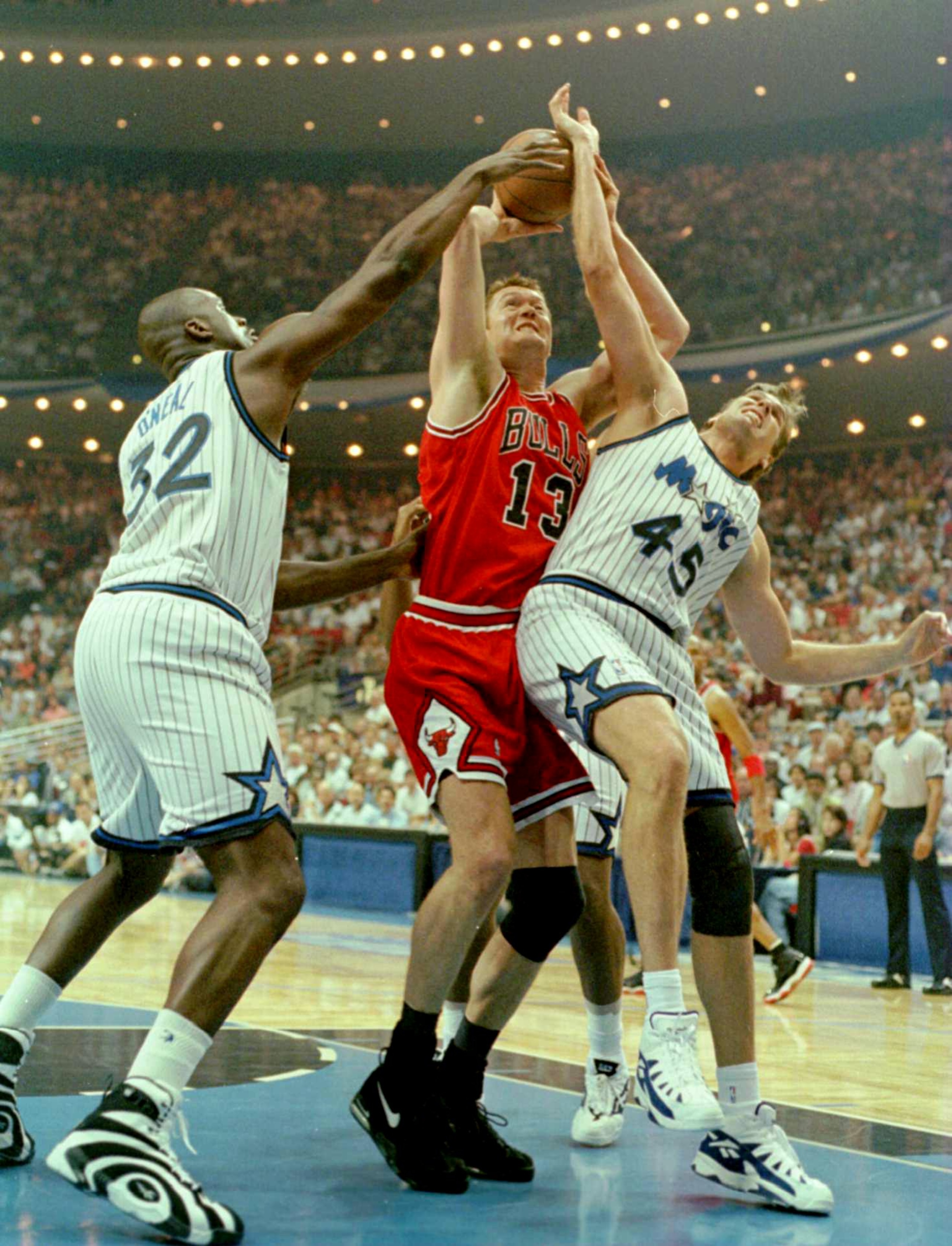 27 May 1996: Shaquille O''Neal #32 and Jon Koncak #45 of the Orlando Magic try to stop a shot by Luc Longley #13 of the Chicago Bulls during the first quarter of Game 4 of the Eastern Conference Final between the Chicago Bulls and the Orlando Magic at the 27 May 1996: Shaquille O''Neal #32 and Jon Koncak #45 of the Orlando Magic try to stop a shot by Luc Longley #13 of the Chicago Bulls during the first quarter of Game 4 of the Eastern Conference Final between the Chicago Bulls and the Orlando Magic at the