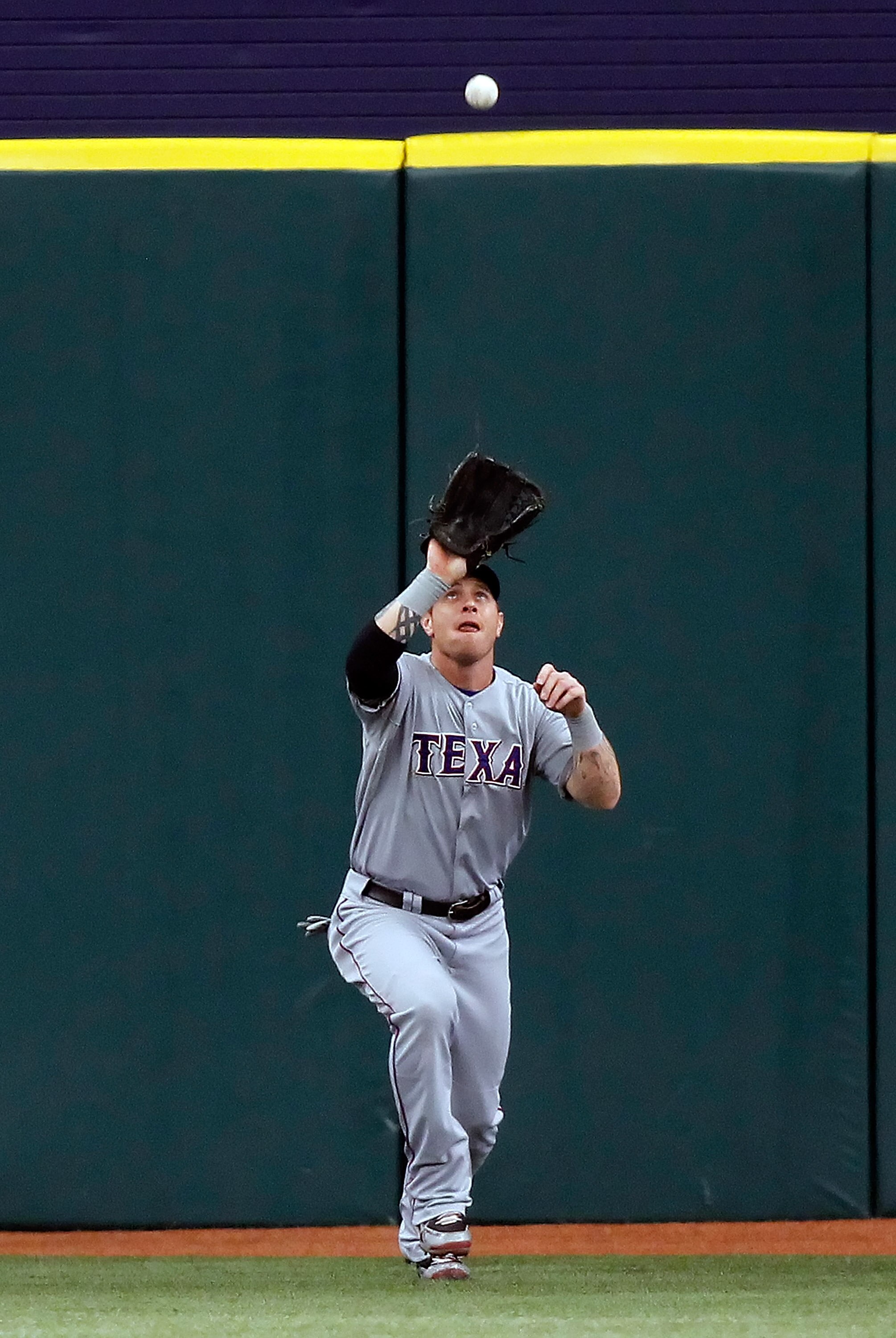 ST. PETERSBURG - OCTOBER 07:  Outfielder Josh Hamilton #32 of the Texas Rangers catches a fly ball against the Tampa Bay Rays during Game 2 of the ALDS at Tropicana Field on October 7, 2010 in St. Petersburg, Florida.  (Photo by J. Meric/Getty Images)