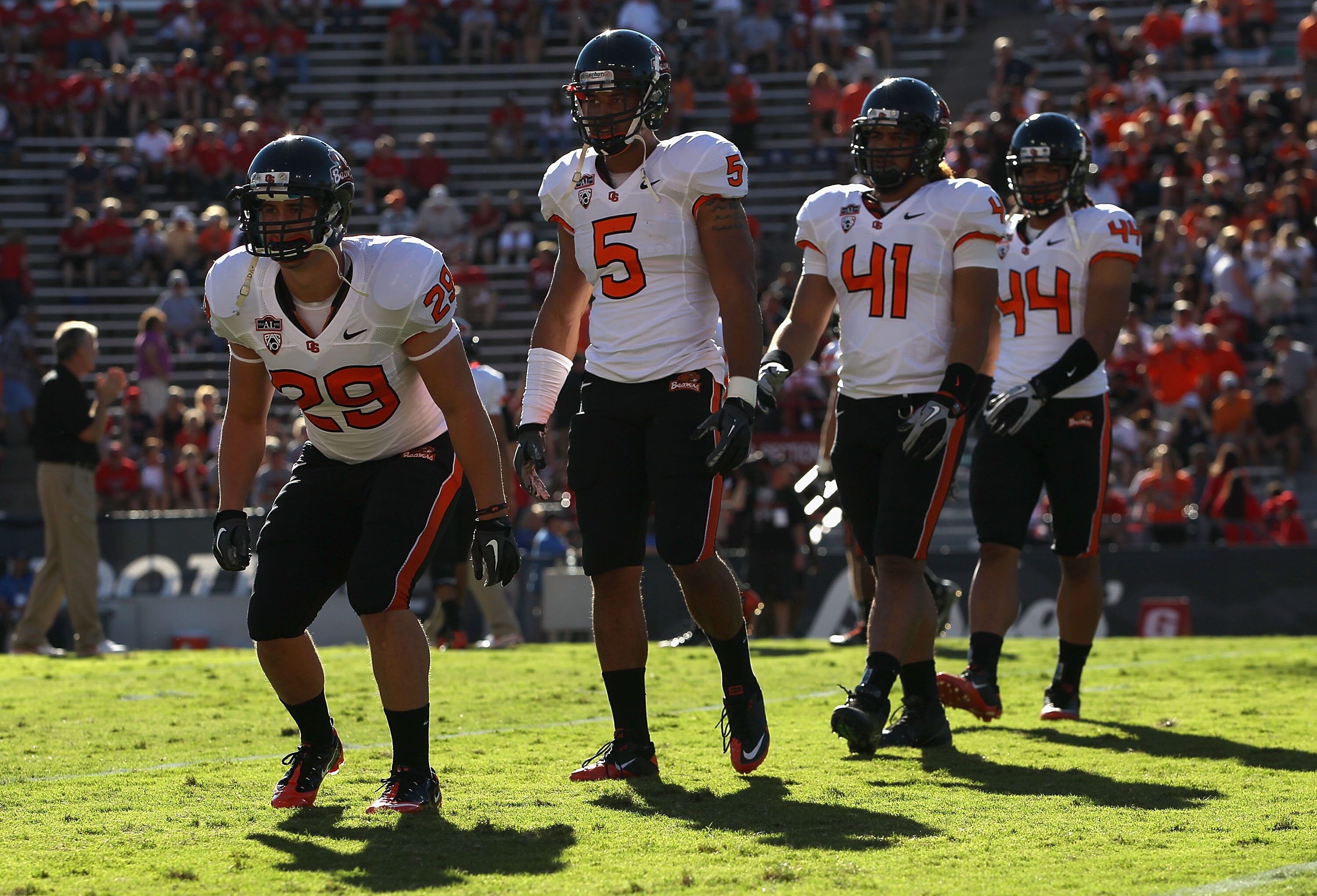 TUCSON, AZ - OCTOBER 09:  (L-R) Zane Norris #29,  Cameron Collins #5, Feti Unga #41 and Uani Unga #44 of the Oregon State Beavers warm up before the college football game against the Arizona Wildcats at Arizona Stadium on October 9, 2010 in Tucson, Arizon