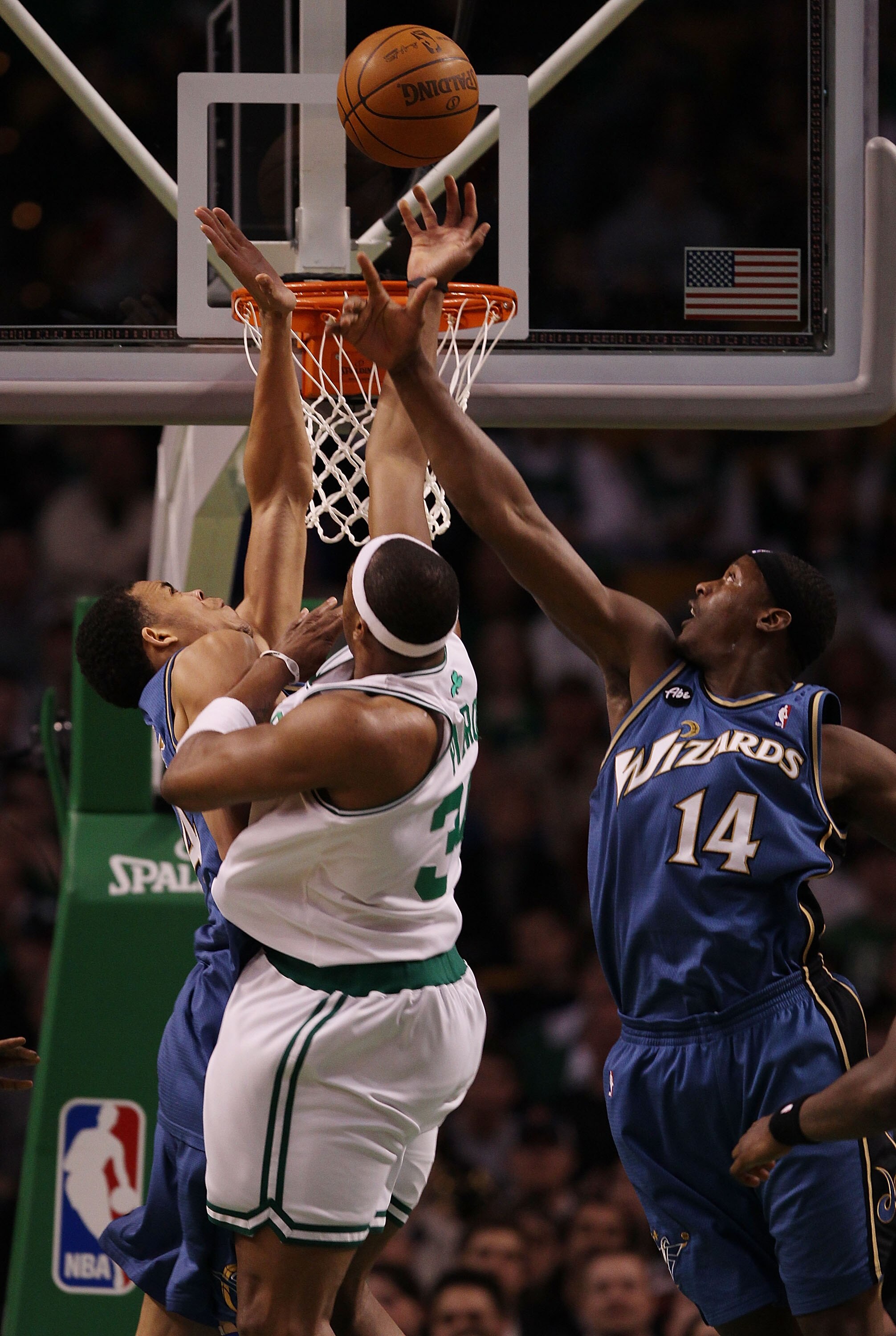 BOSTON - MARCH 07:  Paul Pierce #34 of the Boston Celtics takes a shot as JaVale McGee #34 and Al Thornton #14  of the Washington Wizards defend on March 7, 2010 at the TD Garden in Boston, Massachusetts.  NOTE TO USER: User expressly acknowledges and agr