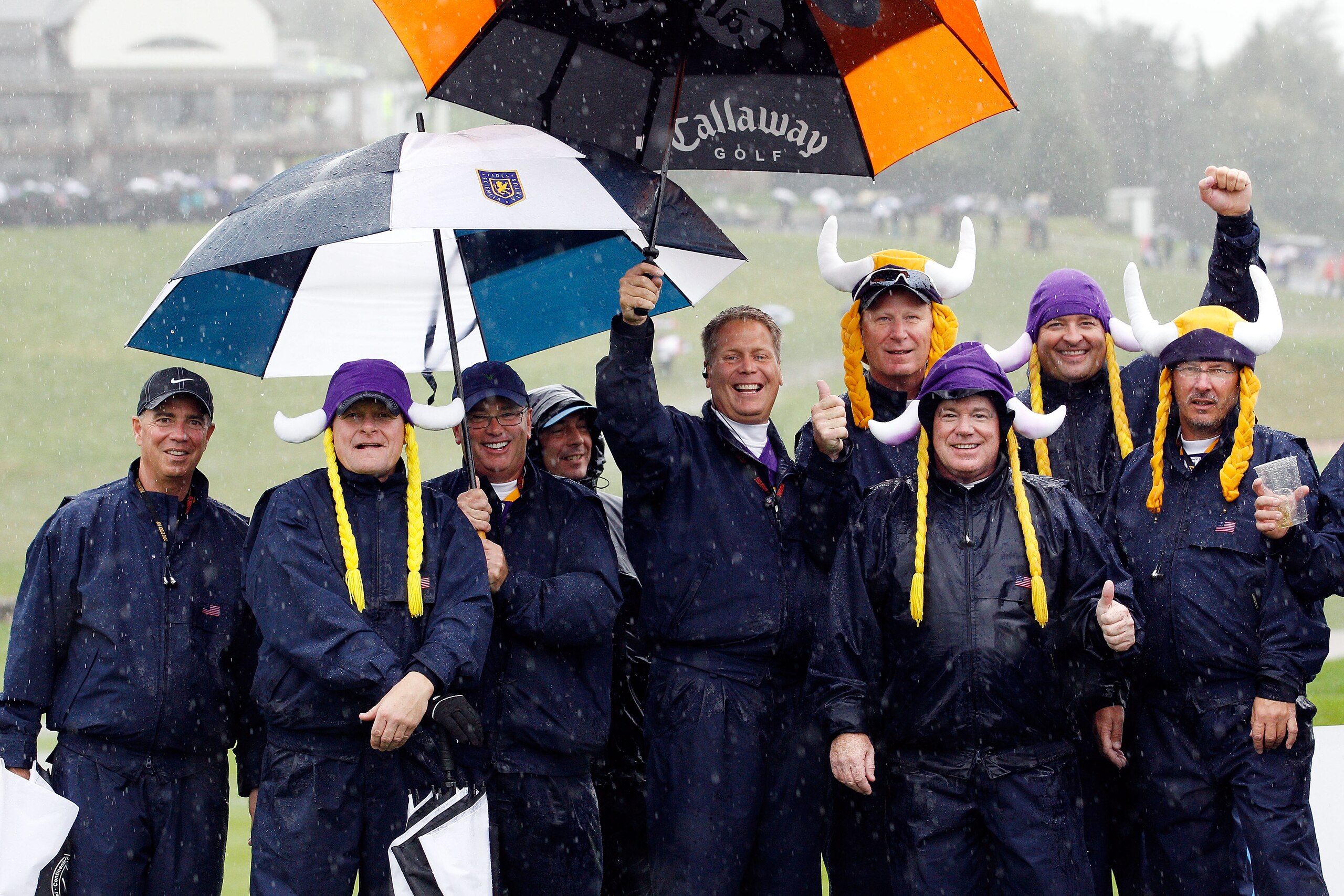 NEWPORT, WALES - OCTOBER 01:  Spectators brave the elements as rain falls and play is suspended during the Morning Fourball Matches during the 2010 Ryder Cup at the Celtic Manor Resort on October 1, 2010 in Newport, Wales.  (Photo by Sam Greenwood/Getty I