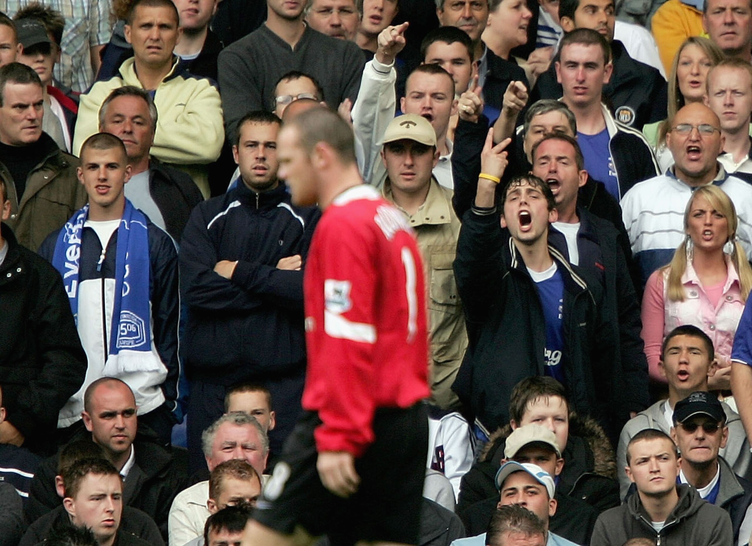LIVERPOOL, ENGLAND -  AUGUST 13 : Wayne Rooney  of Man United is acknowledged by the Everton fans during the Barclays Premiership match between Everton and Manchester United at Goodison Park on August 13, 2005 in Liverpool, England.  (Photo by Clive Bruns