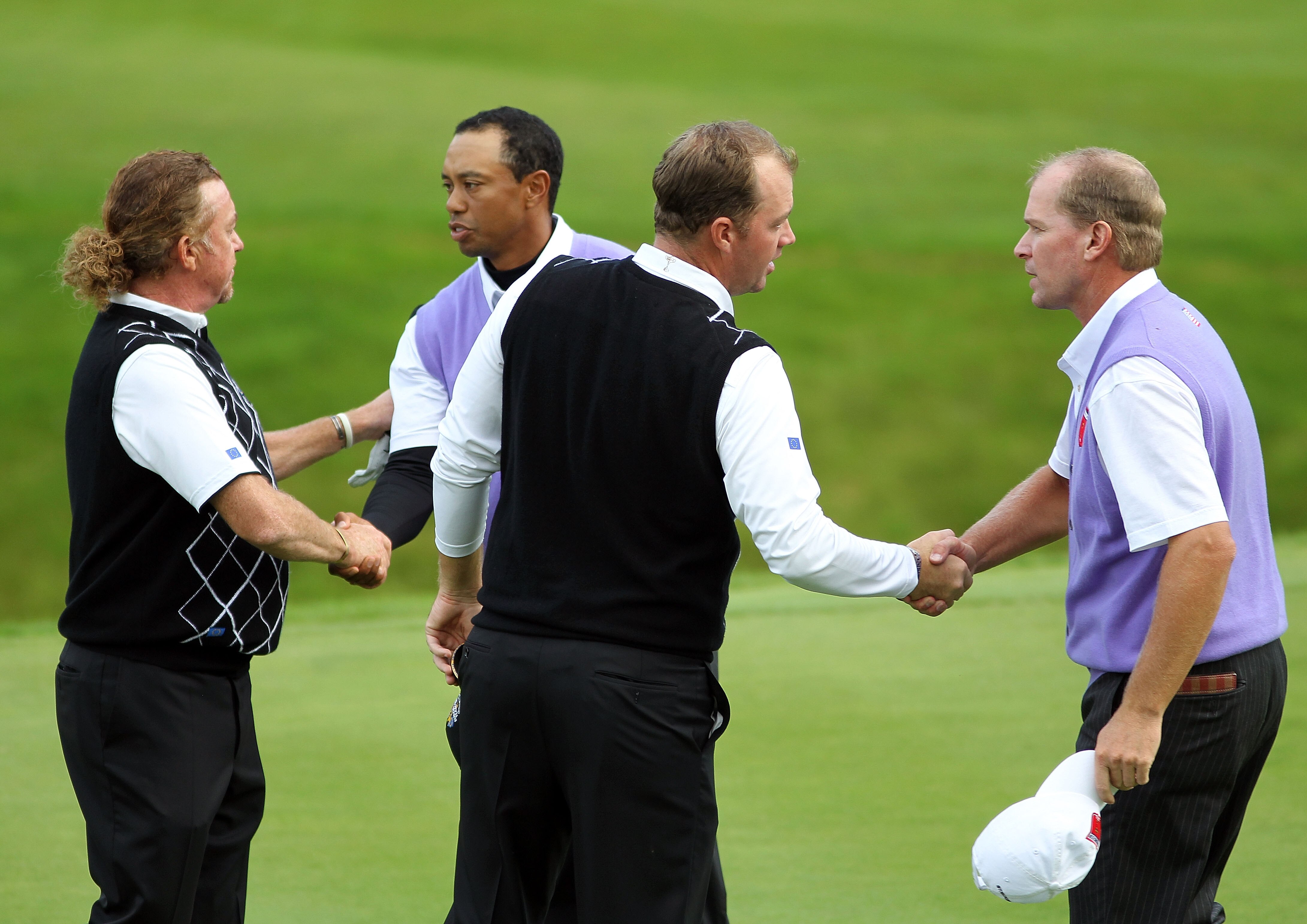 NEWPORT, WALES - OCTOBER 02:  Tiger Woods and Steve Stricker (R) of the USA shake hands with Peter Hanson and Miguel Angel Jimenez (L) after winning their match on the 15th green during the rescheduled Afternoon Foursome Matches during the 2010 Ryder Cup