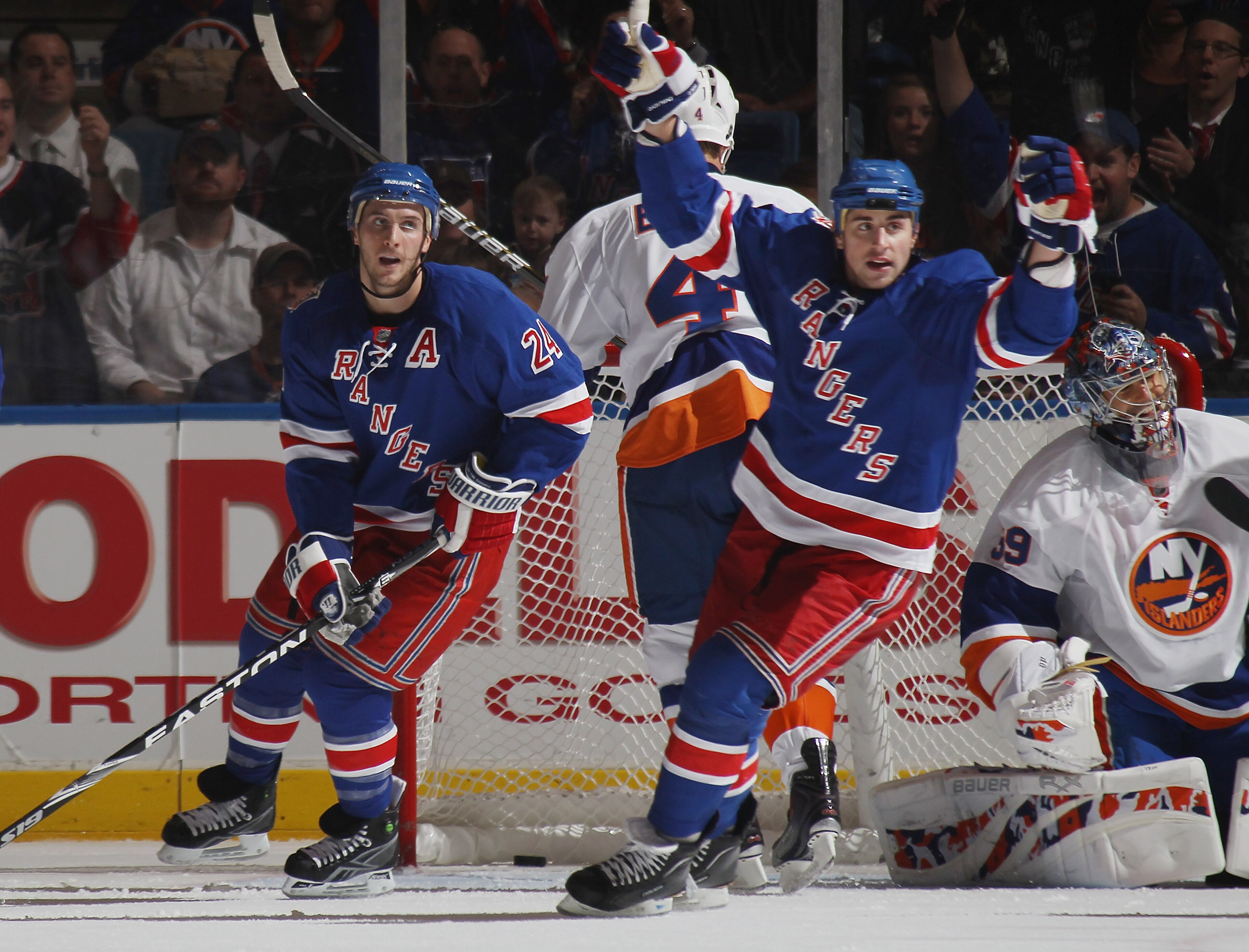 UNIONDALE, NY - OCTOBER 11: (L-R) Brandon Dubinsky #24 and Ryan Callahan #17 of the New York Rangers celebrate a power play goal by Michael Del Zotto (not shown) at 8:28 of the second period against the New York Islanders at the Nassau Coliseum on October