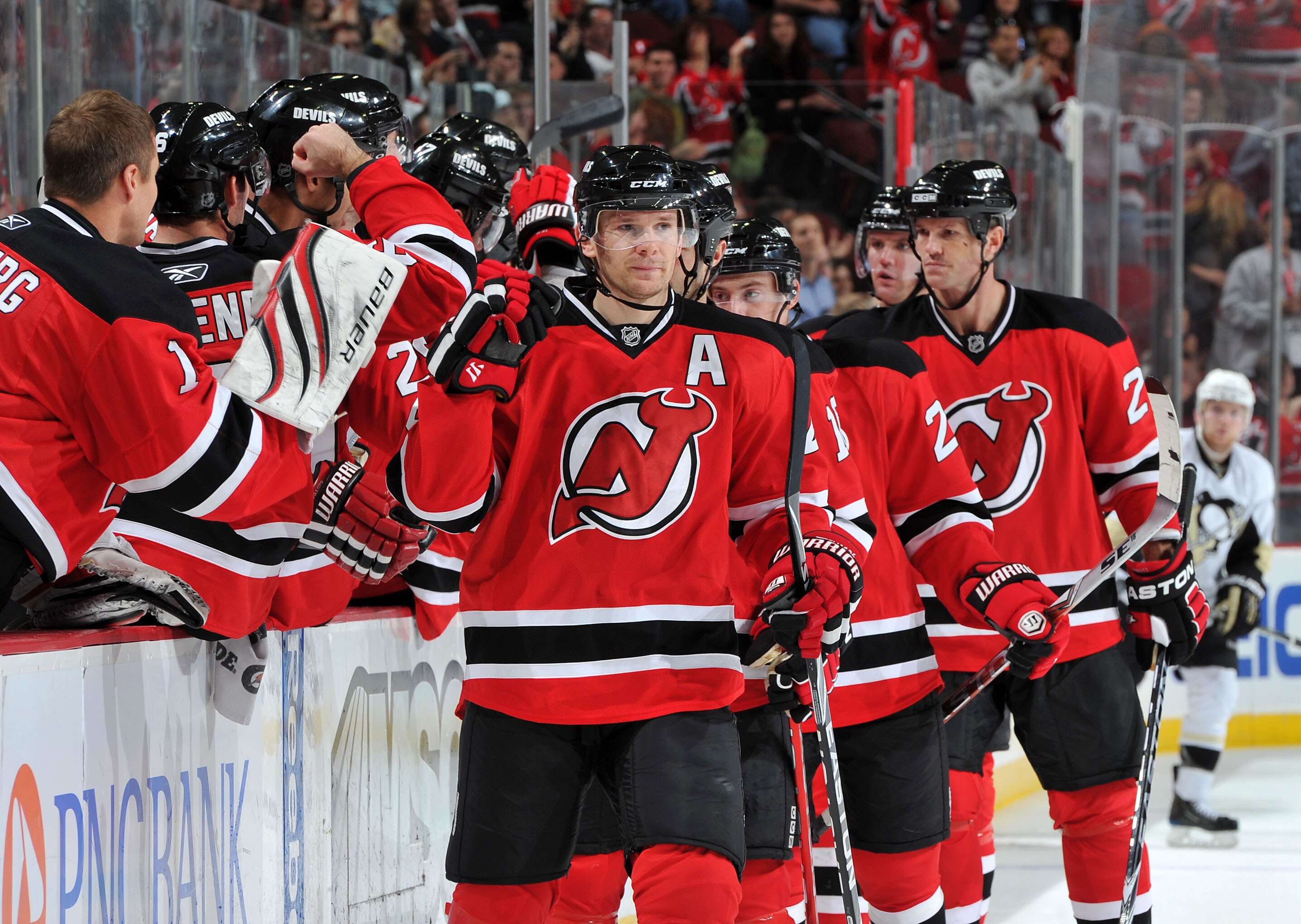 NEWARK, NJ - OCTOBER 11: Patrik Elias #26 of the New Jersey Devils is congratulated after scoring a goal in the third period against the Pittsburgh Penguins at the Prudential Center on October 11, 2010 in Newark, New Jersey. The Penguins defeated the Devi