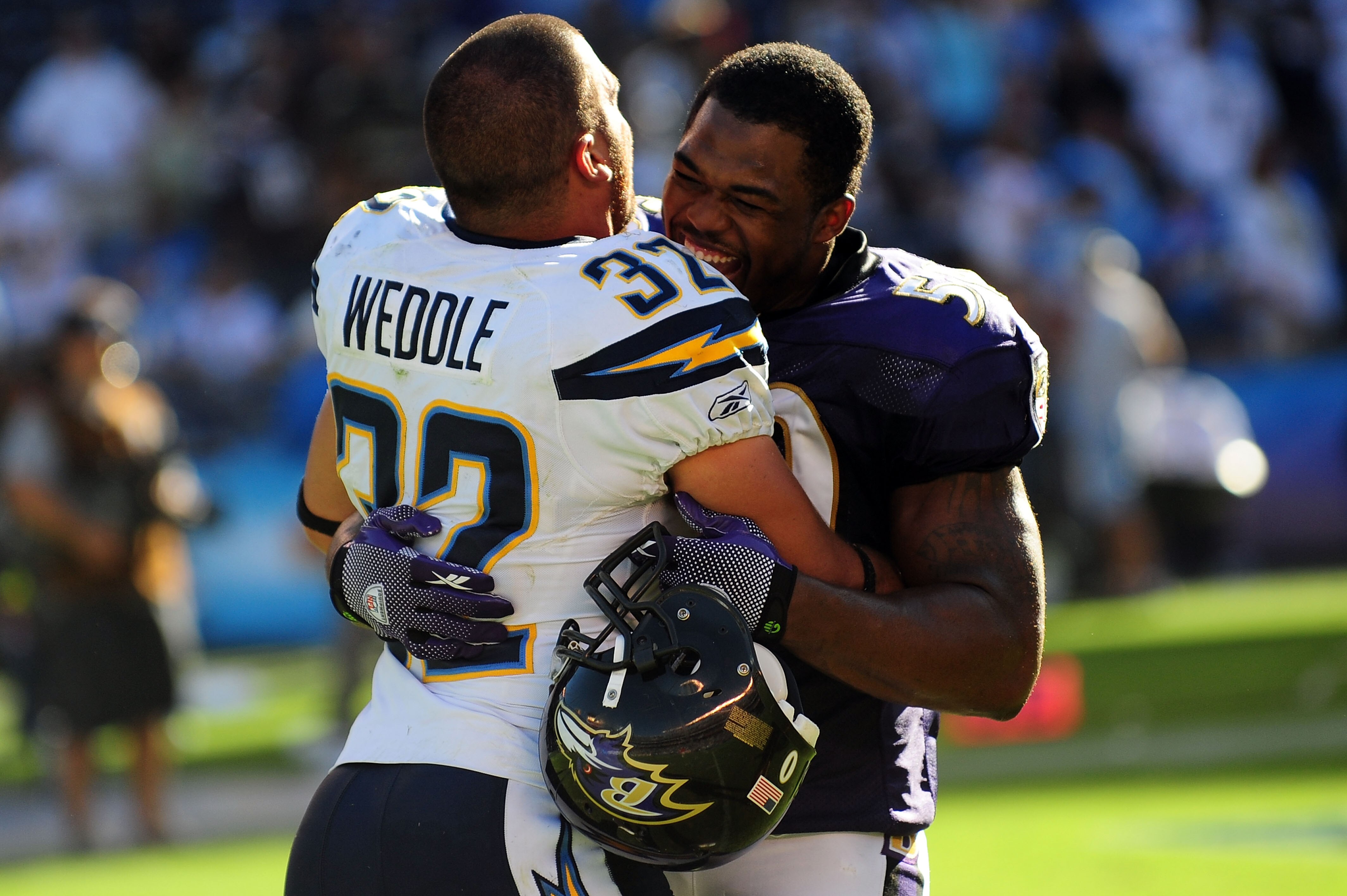 SAN DIEGO - SEPTEMBER 20: Eric Weddle #32 of the San Diego Chargers hugs Antwan Barnes #50 of the Baltimore Ravens after the game at Qualcomm Stadium on September 20, 2009 in San Diego, California.The Ravens defeated the Chargers 31-26  (Photo by Jacob de