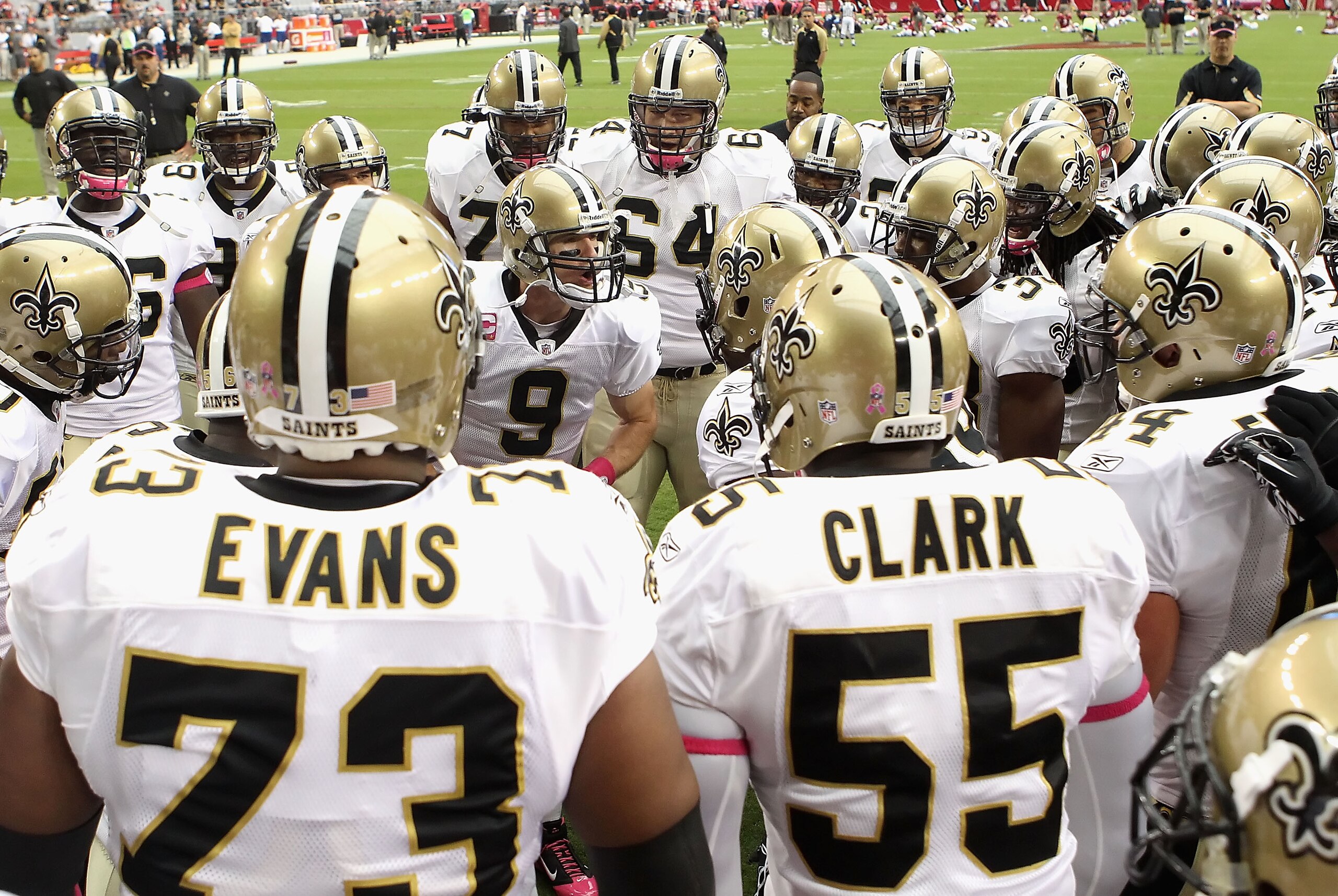 GLENDALE, AZ - OCTOBER 10:  Quarterback Drew Brees #9 of the New Orleans Saints talks with teammates in a huddle prior to the NFL game against the Arizona Cardinals at the University of Phoenix Stadium on October 10, 2010 in Glendale, Arizona. The Cardina