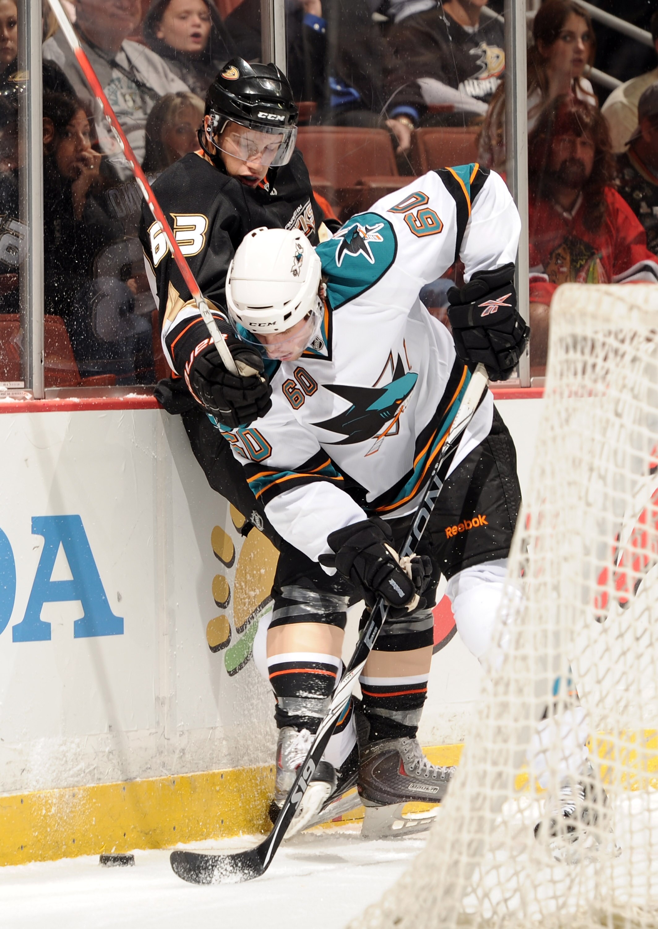 ANAHEIM, CA - SEPTEMBER 22:  Nick Bonino #63 of the Anaheim Ducks and Jason Demers #60 of the San Jose Sharks battle for a puck behind the net during the first period at Honda Center on September 22, 2010 in Anaheim, California.  (Photo by Harry How/Getty