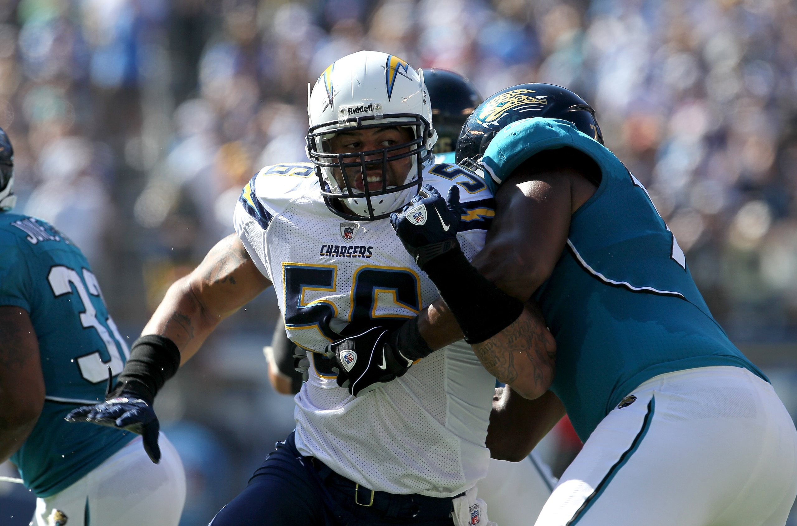 SAN DIEGO - SEPTEMBER 19:  Linebacker Shawne Merriman #56 of the San Diego Chargers fights against the block of tackle Eugene Monroe #75 of the Jacksonville Jaguars at Qualcomm Stadium on September 19, 2010 in San Diego, California. The Chargers won 38-13