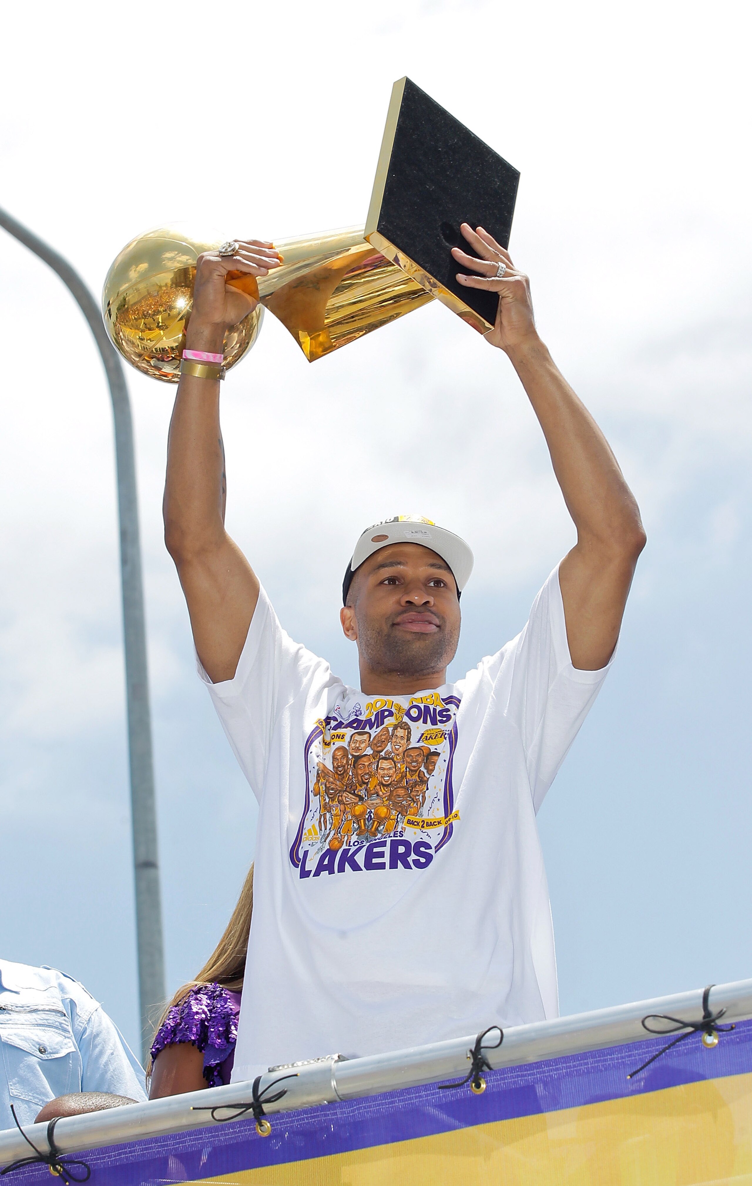 LOS ANGELES, CA - JUNE 21:  Los Angeles Lakers point guard Derek Fisher hoists the championship trophy while riding in the victory parade for the the NBA basketball champion team on June 21, 2010 in Los Angeles, California. The Lakers beat the Boston Celt