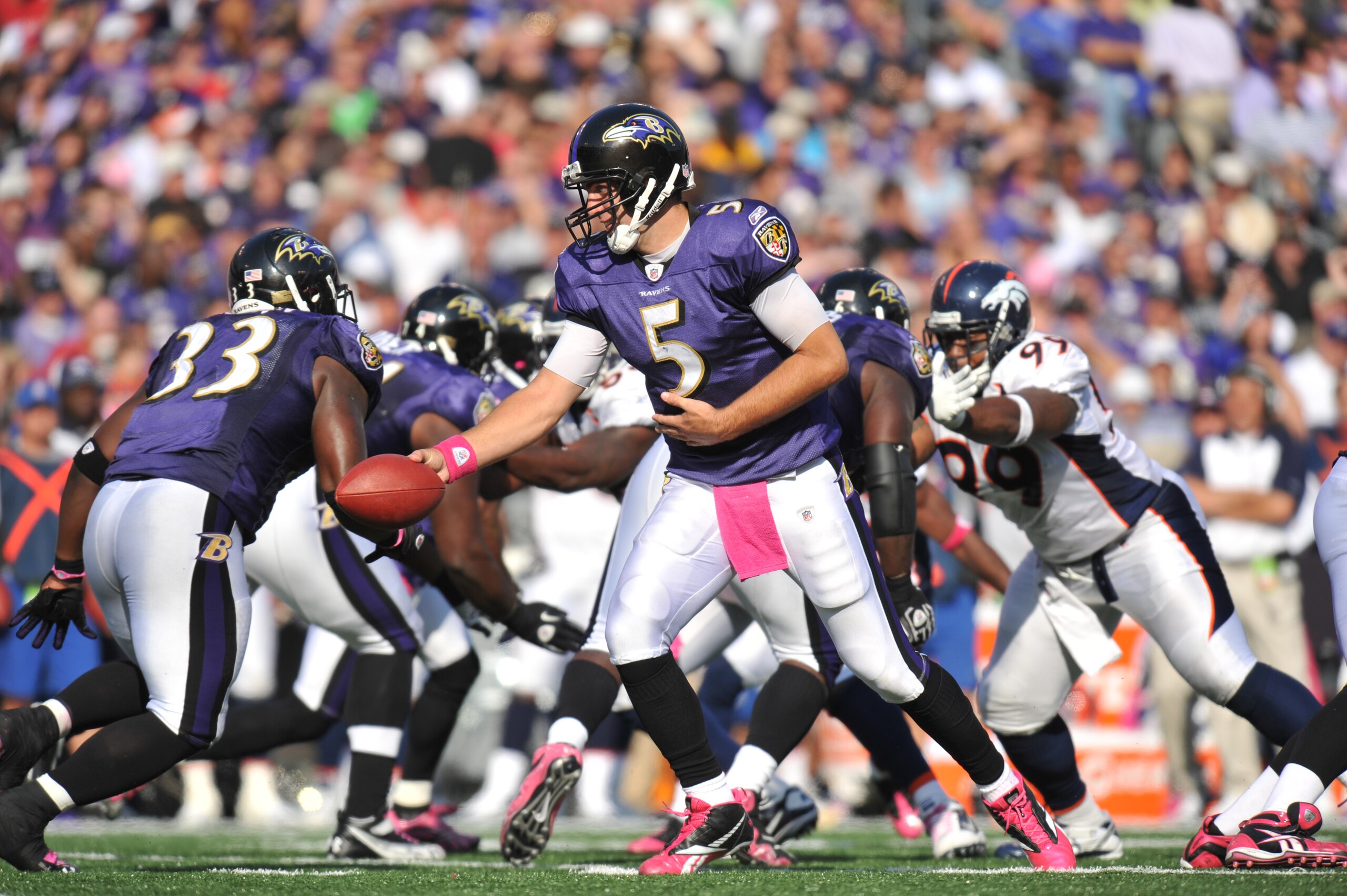 BALTIMORE, MD - OCTOBER 10: Joe Flacco #5 of the Baltimore Ravens hands off during the game against the Denver Broncos at M&T Bank Stadium on October 10, 2010 in Baltimore, Maryland. Players wore pink in recognition of Breast Cancer Awareness Month. The R