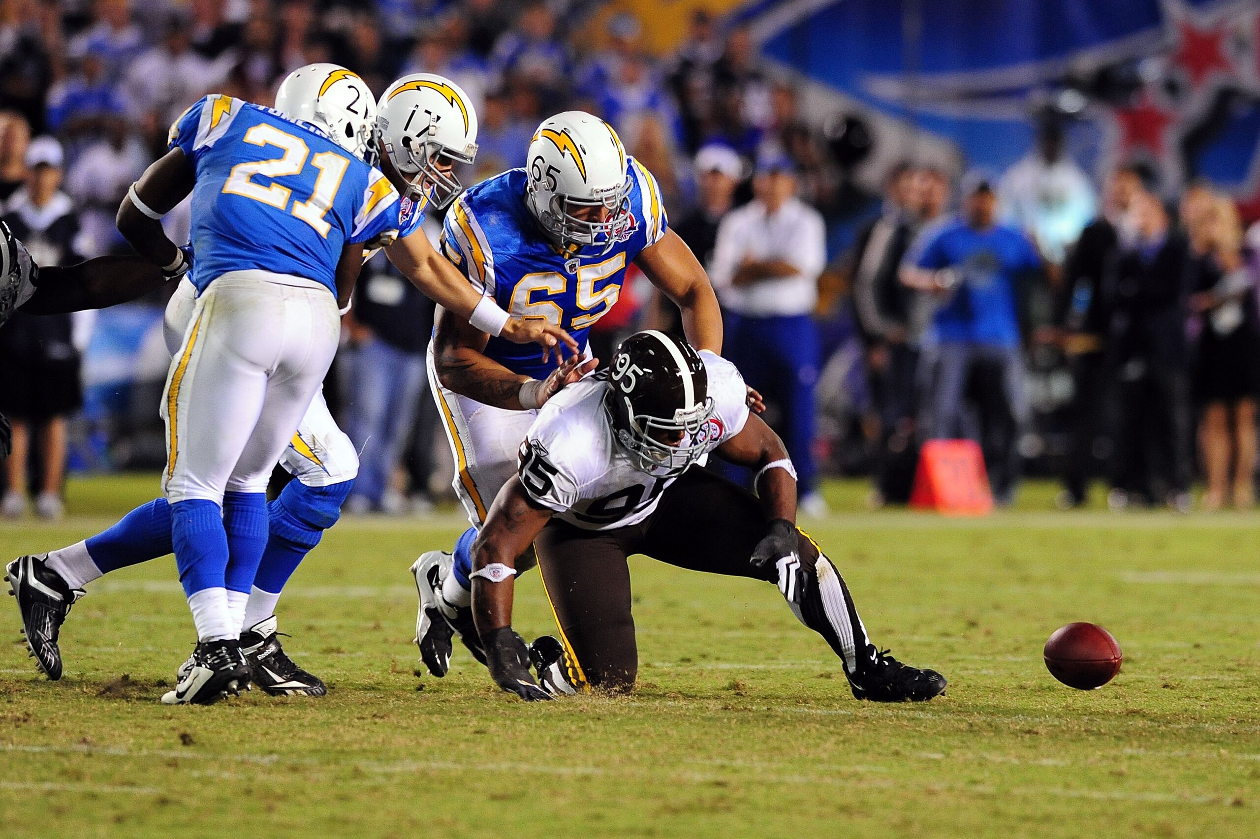 SAN DIEGO - OCTOBER 19:  Philip Rivers #17 of the San Diego Chargers fumbles the ball in which Darrell Reid #95 of the Denver Broncos recovered it at Qualcomm Stadium on October 19, 2009 in San Diego, California.  (Photo by Jacob de Golish/Getty Images)