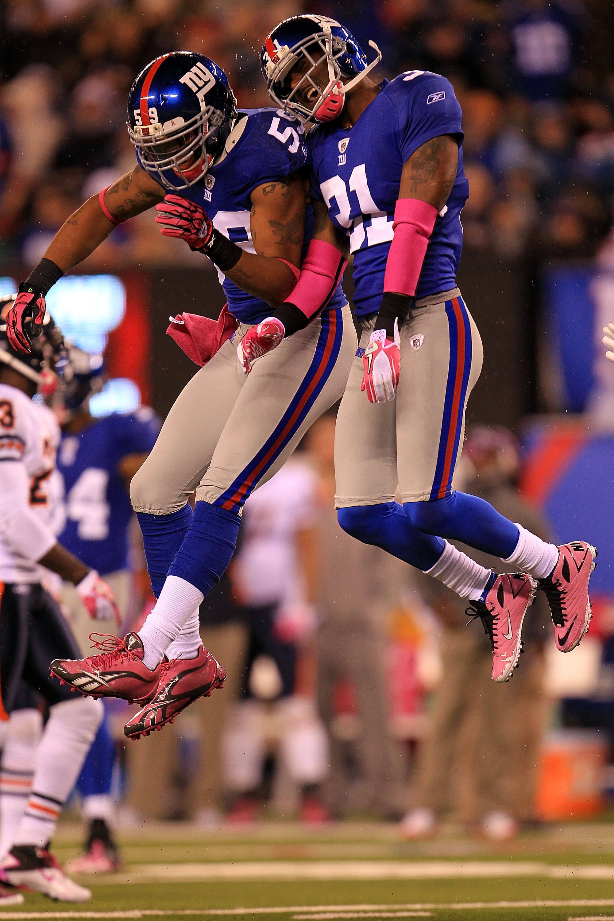 EAST RUTHERFORD, NJ - OCTOBER 03:  Aaron Ross #31 of the New York Giants celebrates after an interception against the Chicago Bears with teammate Michael Boley #59 at New Meadowlands Stadium on October 3, 2010 in East Rutherford, New Jersey.  (Photo by Ch