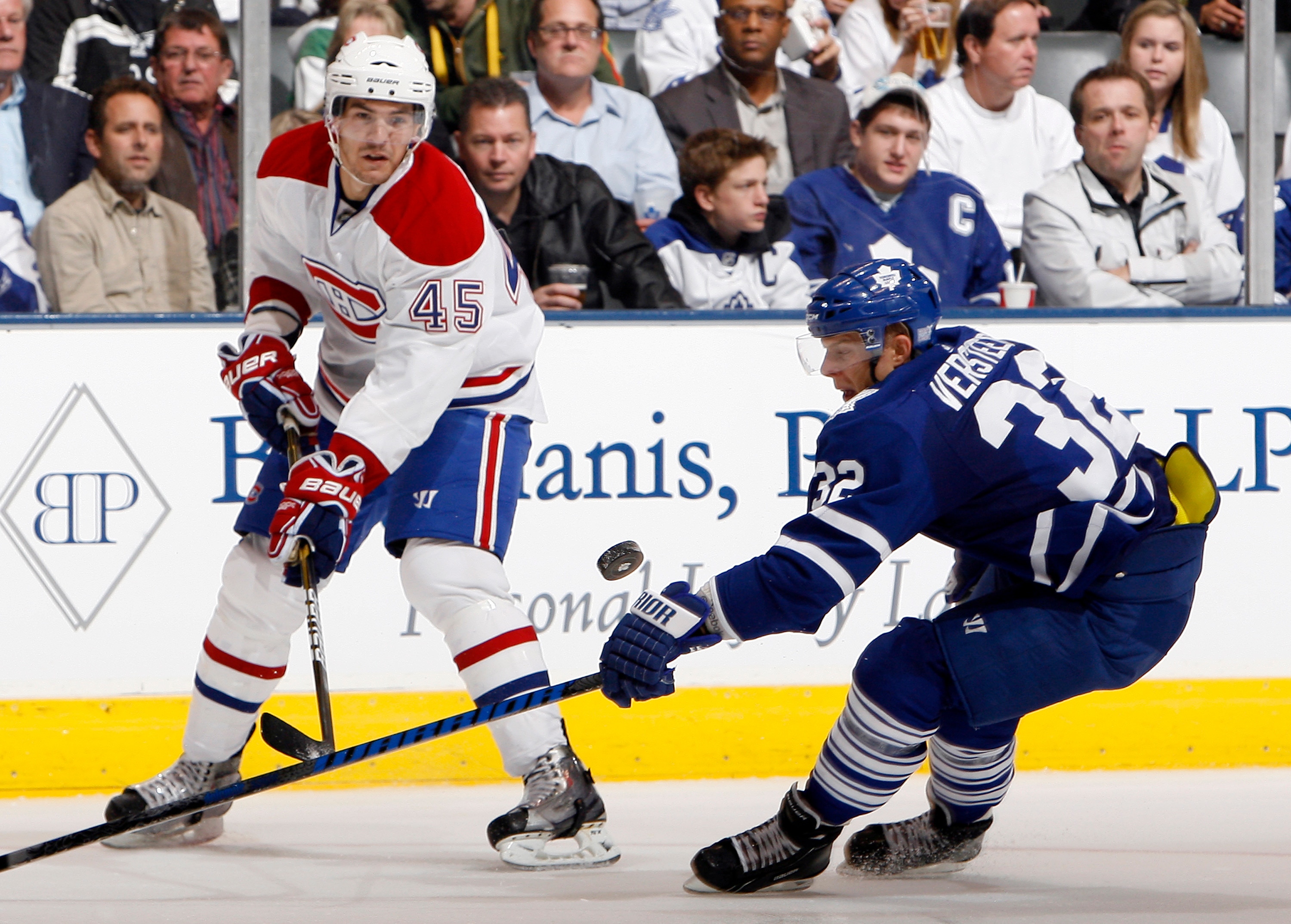 TORONTO - OCTOBER 7: Kris Versteeg #32 of the Toronto Maple Leafs tries to stop Alexandre Picard #45 of the Montreal Canadiens during a regular season NHL game against the Toronto Maple Leafs at the Air Canada Centre October 7, 2010 in Toronto, Ontario, C