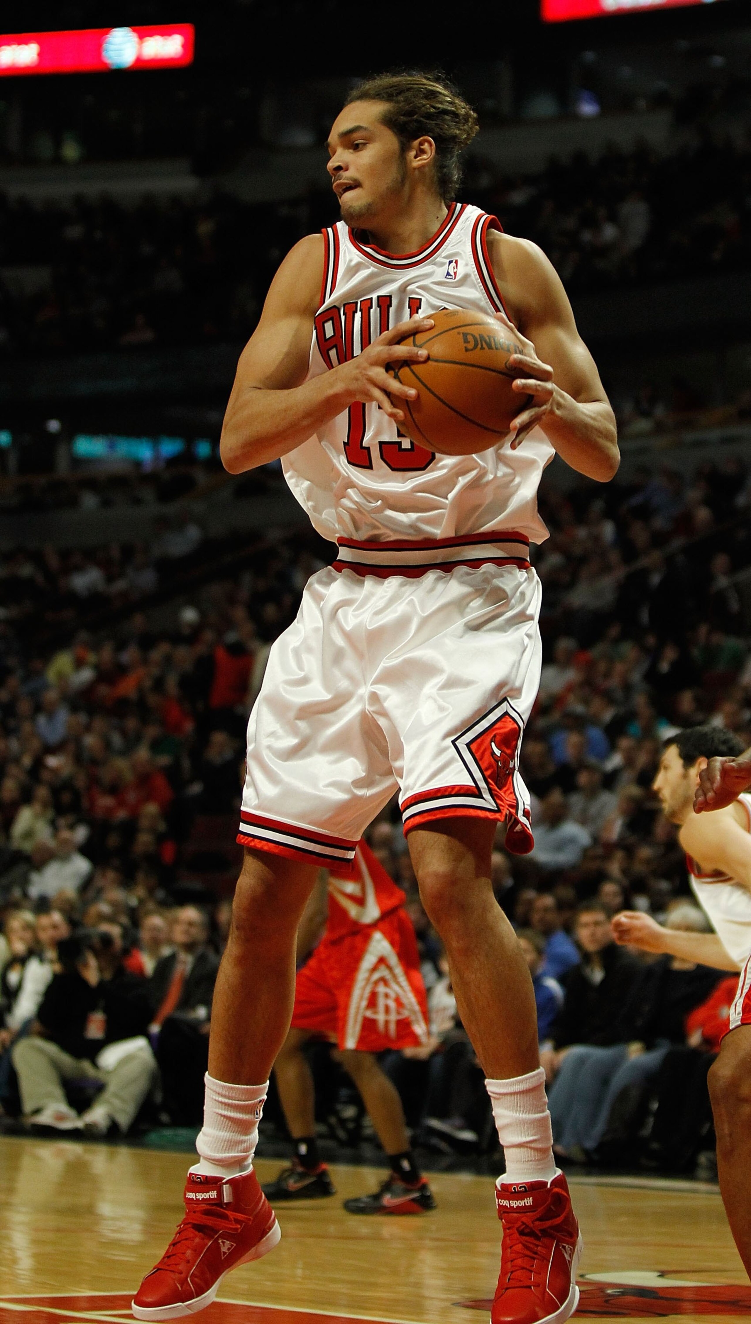 CHICAGO - MARCH 22: Joakim Noah #13 of the Chicago Bulls grabs a rebound against the Houston Rockets at the United Center on March 22, 2010 in Chicago, Illinois. The Bulls defeated the Rockets 98-88. NOTE TO USER: User expressly acknowledges and agrees th