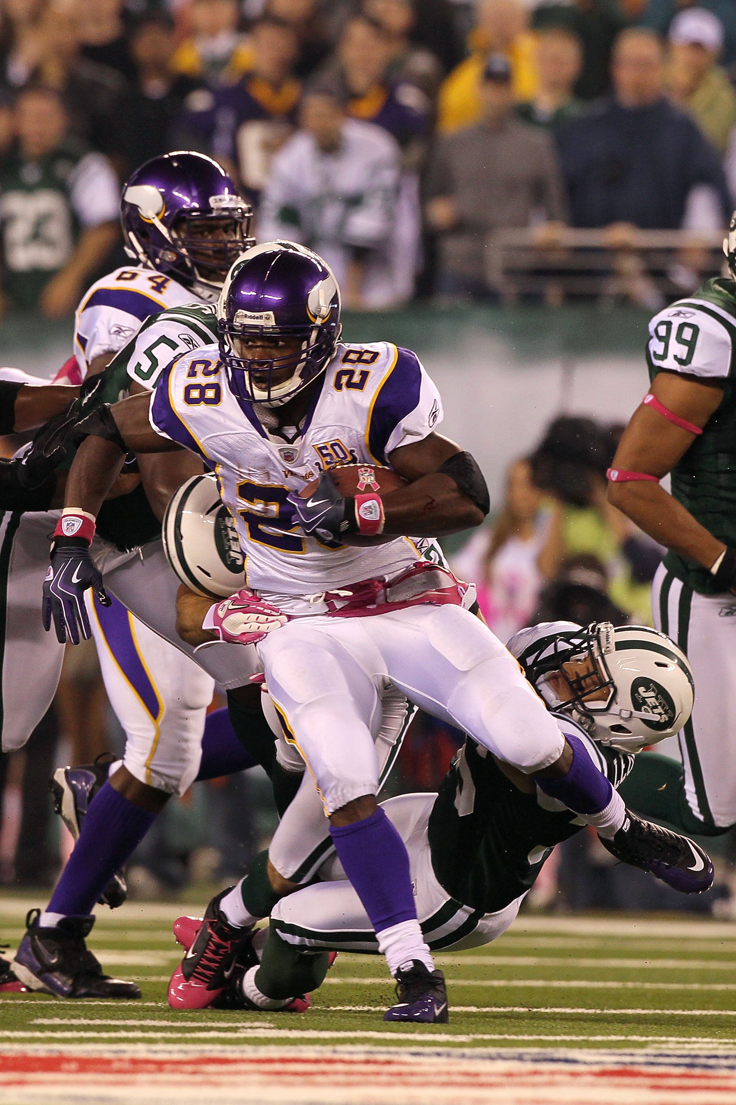 EAST RUTHERFORD, NJ - OCTOBER 11:  Adrian Peterson #28 of the Minnesota Vikings runs the ball against Jim Leonhard #36 of the New York Jets at New Meadowlands Stadium on October 11, 2010 in East Rutherford, New Jersey. The Jets won 29-20. (Photo by Jim Mc